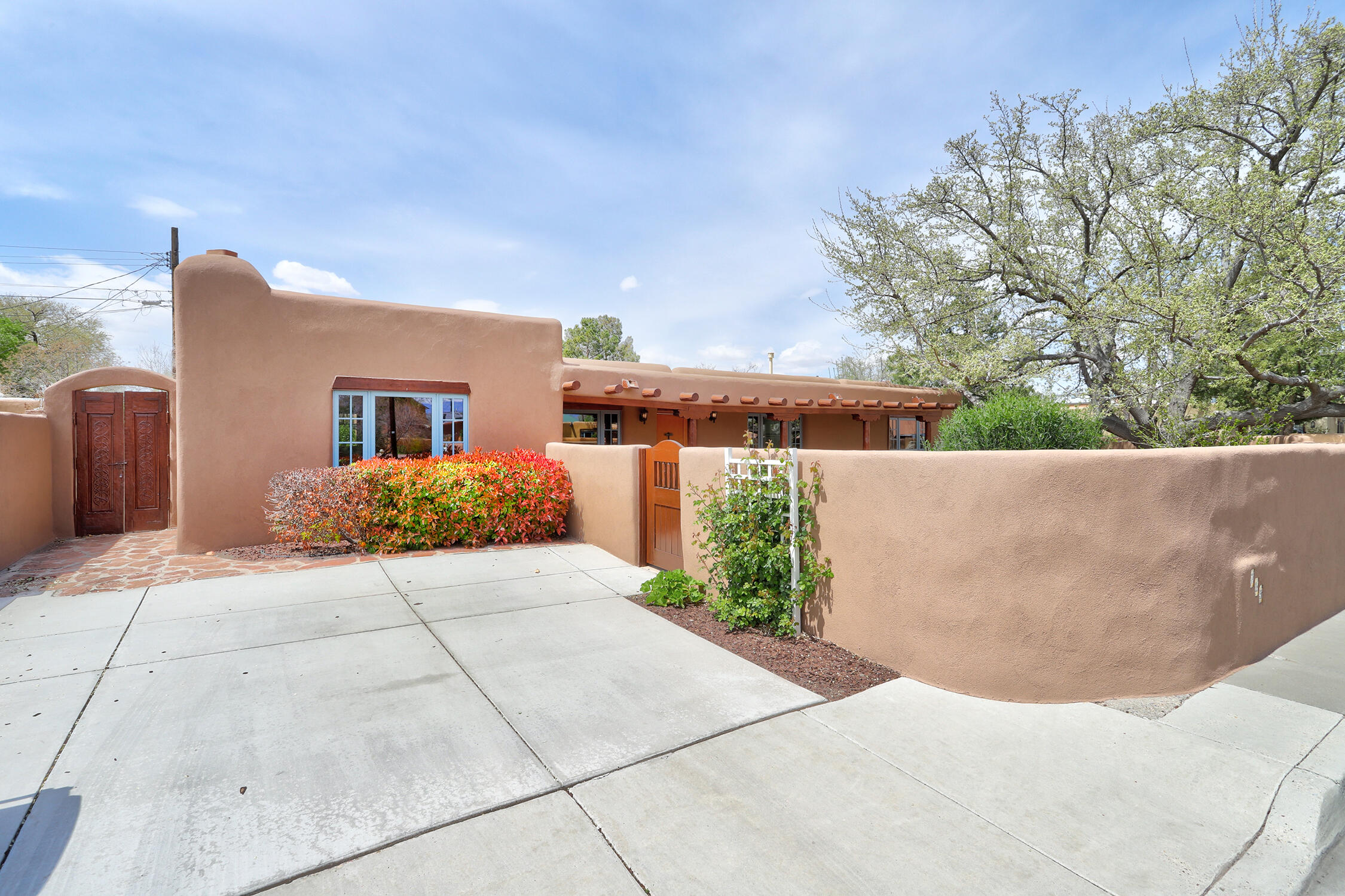 Beautifully updated Watson Adobe near Old Town!  If you have been dreaming of an authentic adobe with vigas, herringbone wood ceilings, brick floors, kiva fireplace, wood lentils above doors and windows, you have found it! Totally remodeled kitchen with coved vigas, farm sink, beautiful cabinetry, butcher block counters 5 burner gas stove. Gracious outdoor entertaining areas, boasting outdoor kiva, gas grill, a pergola, an enchanting covered patio. Mature landscaping with trees, shrubs, bulbs, hand-made gate & more. Pella Windows, American Clay walls and Variance in kitchen and baths. Walk to Old Town, Tiguex Park, Antiquity, Seasons, Sawmill, Duran's.  Live your BEST life and own a piece of history in the Historic Watson District!