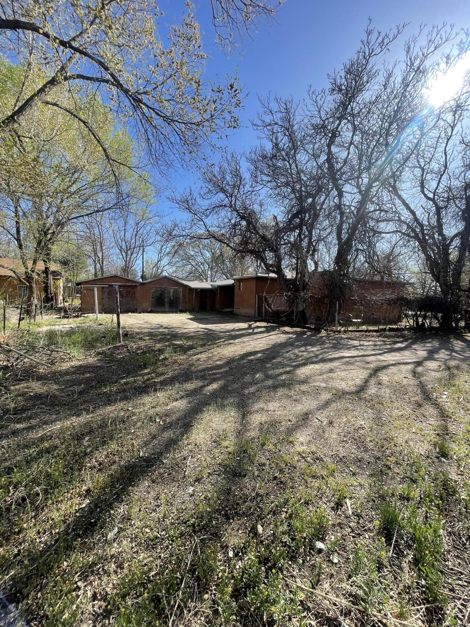 This Priced to sell investment property! Issitting on a huge corner lot! It is a blank canvas with great potential with Backyard Access. Quick drive to down town Albuquerque or I-25.