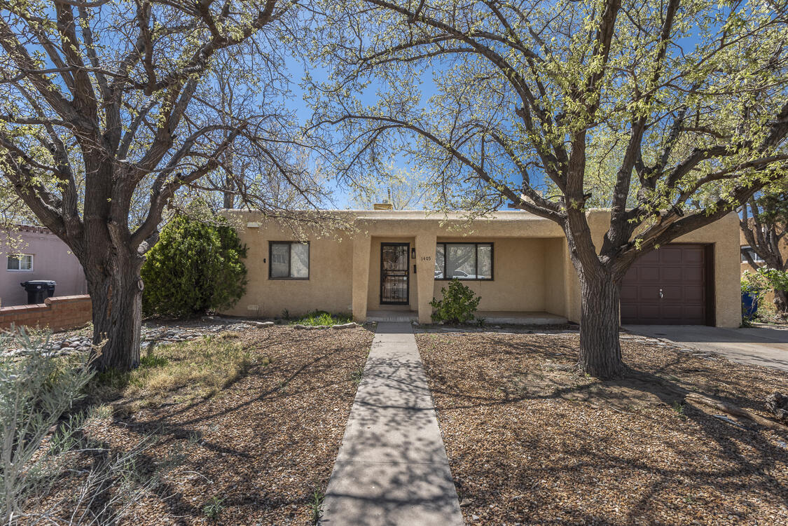 Charming home in UNM's desirable Altura Park area neighborhood. This home offers a brand new TPO roof and a light-filled floor plan including two bedrooms plus an additional office/flex space off the updated kitchen. The open kitchen and living space features large picture windows, coved ceilings, solid oak hardwood floors and a cozy fireplace. Delightful covered patio (also with new TPO roof) and spacious backyard with views of the West Mesa volcanos and additional storage. Located near new Whole Foods, UNM, parks and quick access to 1-40.