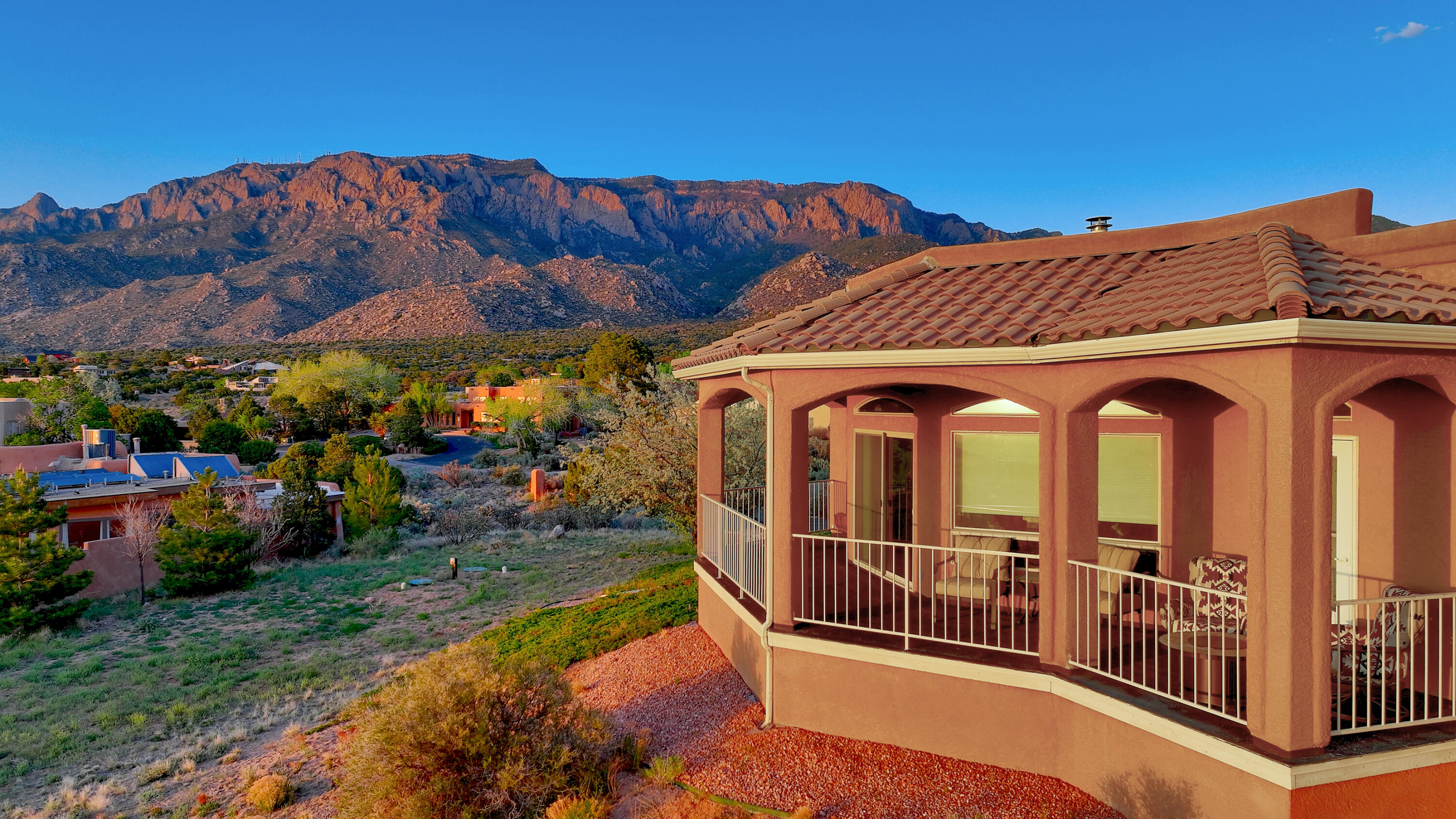 Breathtaking views of the Sandia Mountains, Sunsets, and City lights! The multiple living spaces capture the views from different angles. Be blown away by the Chefs kitchen with granite counter tops, large island, Thermador gas range, huge pantry and laundry room, and beautiful cabinetry. The primary suite is spacious with multiple closets and spa like en-suite bathroom. The 4th bedroom that also has an en-suite bathroom which is great for guests! On the other wing are the additional two bedrooms and full bathroom. Some other features include Owned Solar Panels, Refrigerated air conditioning, and swim spa. This is a huge lot with plenty of outdoor space and patios galore. Don't forget movie night in the lower level plus the workout room. This is an incredible property!