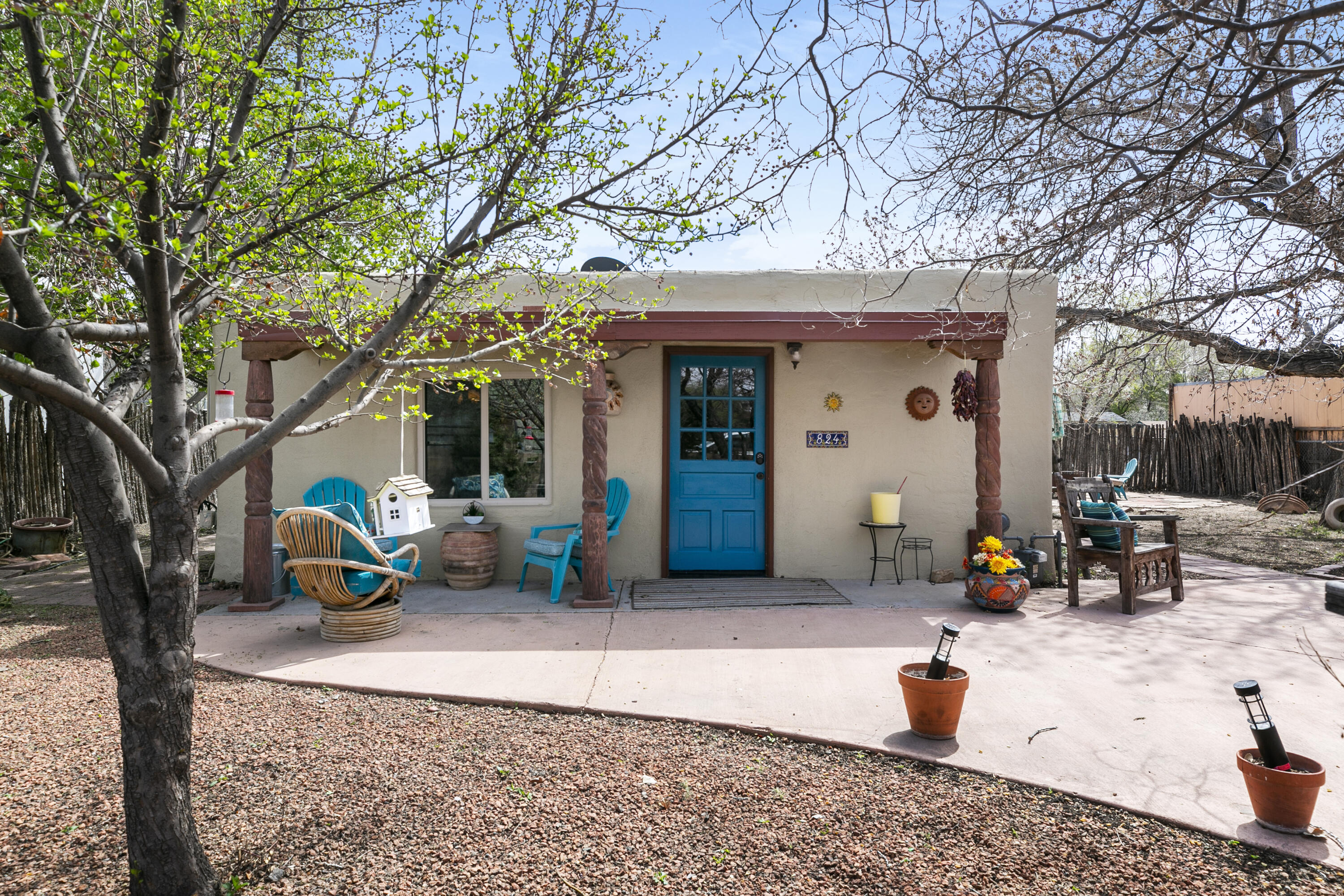 Live in the serenity of Los Ranchos in this beautiful adobe home beneath the trees.  The fully fenced property brings privacy and lots of outdoor space to enjoy gardening, entertaining, or your morning coffee with nature.  Inside, you'll find timeless brick floors and beamed ceilings.  The kitchen comes with all appliances!  The bedroom suite has attached bathroom with large shower and water closet.  The home is heated and cooled with two mini split units for added comfort.  Enjoy the outdoors with access to trails for walking or biking, access to Rio Grande and the Bosque nearby!