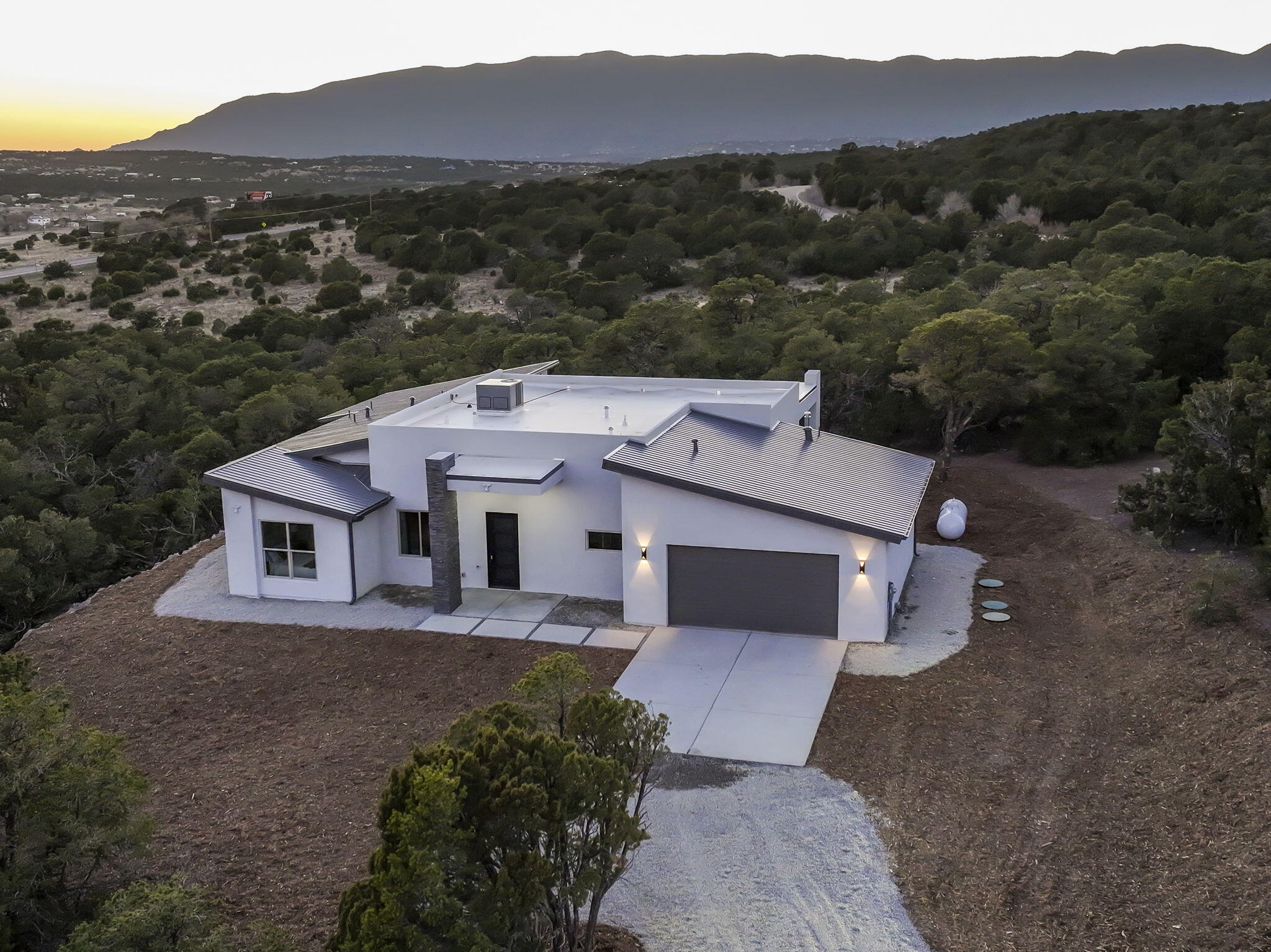 Step into your dream home in the scenic beauty of Tijeras, New Mexico. This brand-new construction embodies the perfect blend of modern luxury and charm. With spacious interiors bathed in natural light and thoughtfully crafted architectural details, every corner exudes elegance and comfort. Enjoy stunning views of the surrounding landscape from large windows or relax in the serene outdoor living spaces. From the gourmet kitchen, the 3 luxurious bedrooms plus an office and spa-like bathrooms, every aspect of this home is designed to elevate your living experience. Whether you're unwinding by the fireplace or entertaining guests on the large patio with endless views, this oasis offers a sanctuary where you can truly feel at home. Build a life you do not need to vacation from!