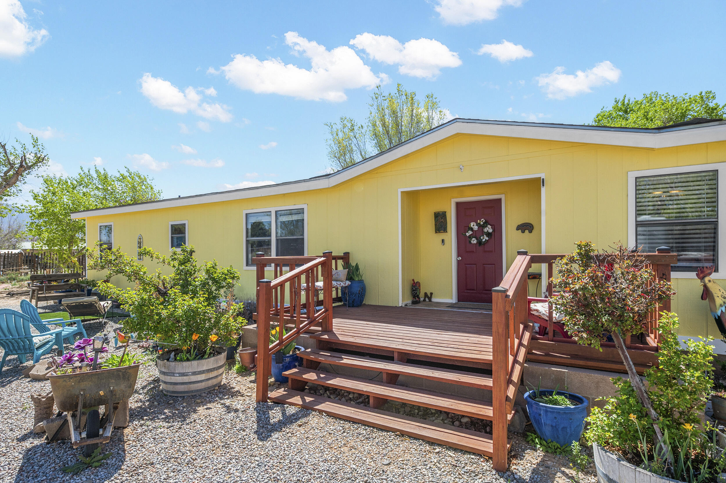 Live the equestrian dream at this private, 1-acre horse property in Corrales! Custom iron gates welcome you to a new redwood front deck and recently painted back deck, grass lawn with auto watering system and a fish pond. Covered horse stalls, round pen, and arena create the perfect setting for your equestrian pursuits. Take comfort inside the beautiful 4-bedroom, 2-bathroom home with beamed ceilings, 2-living areas, wood burning fireplace, and a formal dining room. The country kitchen is filled with light and features an island, 5-burner gas stove, double oven, and a large pantry. The primary suite with a luxuriously updated bathroom and soaking tub is the ideal place to relax and unwind after a day with the horses. Keep cool with refrigerated air this summer, 2 new units installed 4/17!