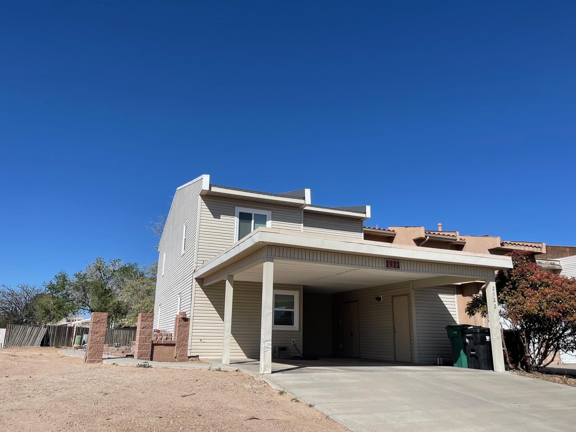 Welcome home to this adorable townhouse nestled in desirable Rio Rancho! Close to schools, shopping and restaurants featuring spacious bedrooms with one on the main level. This 4 bedroom, 2.5 bath home has undergone updates that include vinyl LifeProof flooring, new sliding glass doors, new kitchen cabinets and butcher block countertops, sink, vent hood installed March 2024.  The upstairs features generous size bedrooms with jack and jill bathroom with new tub surround installed February 2024.  The primary bedroom suite features a ceiling fan, two closets, large vanity area and shower.   The roof had maintenance completed in February 2024.  Large corner lot has backyard access and storage shed.  The carport area includes additional storage.  Did I mention the huge pantry?  Move in ready!