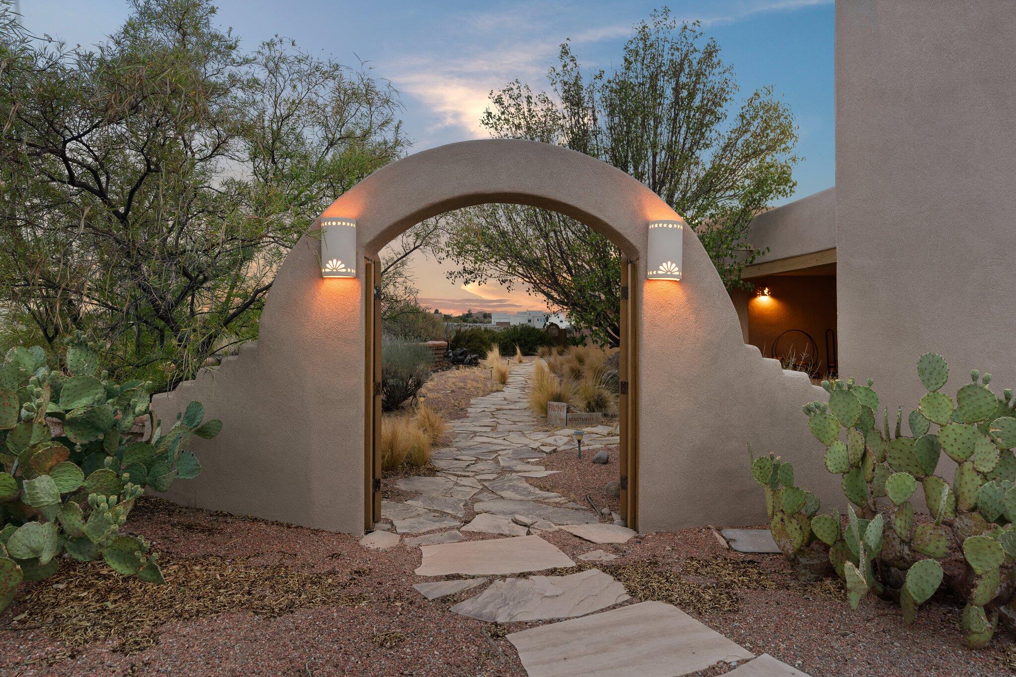 Beautiful guest casita or multigenerational living with ample space & privacy has its own entrance, full bdr/bath, kitchen & living rm w/kiva fireplace! Nature abounds in this incredible setting with mtn views, beautiful sunrises & sunsets, tranquil courtyard and natural landscape; all nestled in the foothills of Placitas. Open entertaining floor plan shows off a great room w/mtn views, vigas & kiva fireplace, formal dining, separate study and huge lower level game/media room!  SW style kitchen, island, bkfst nook w/built-in banco & mesa views!  Primary suite features a sauna, sitting room, fireplace, walk-in closet, and covered patio. Newer HVAC units & roof restoration!  Paved driveway, cul-de-sac, private courtyard, two waterfalls & covered portals make this a spectacular property!