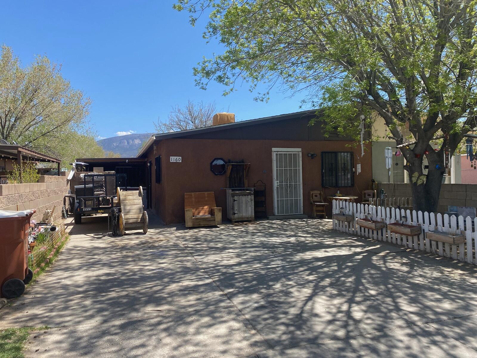 Welcome to this three bedroom, two bathroom townhouse. Newer furnace and water heater, tile floors, and carpet in the bedrooms. Close to a park and Railrunner access! Come see your new home today!