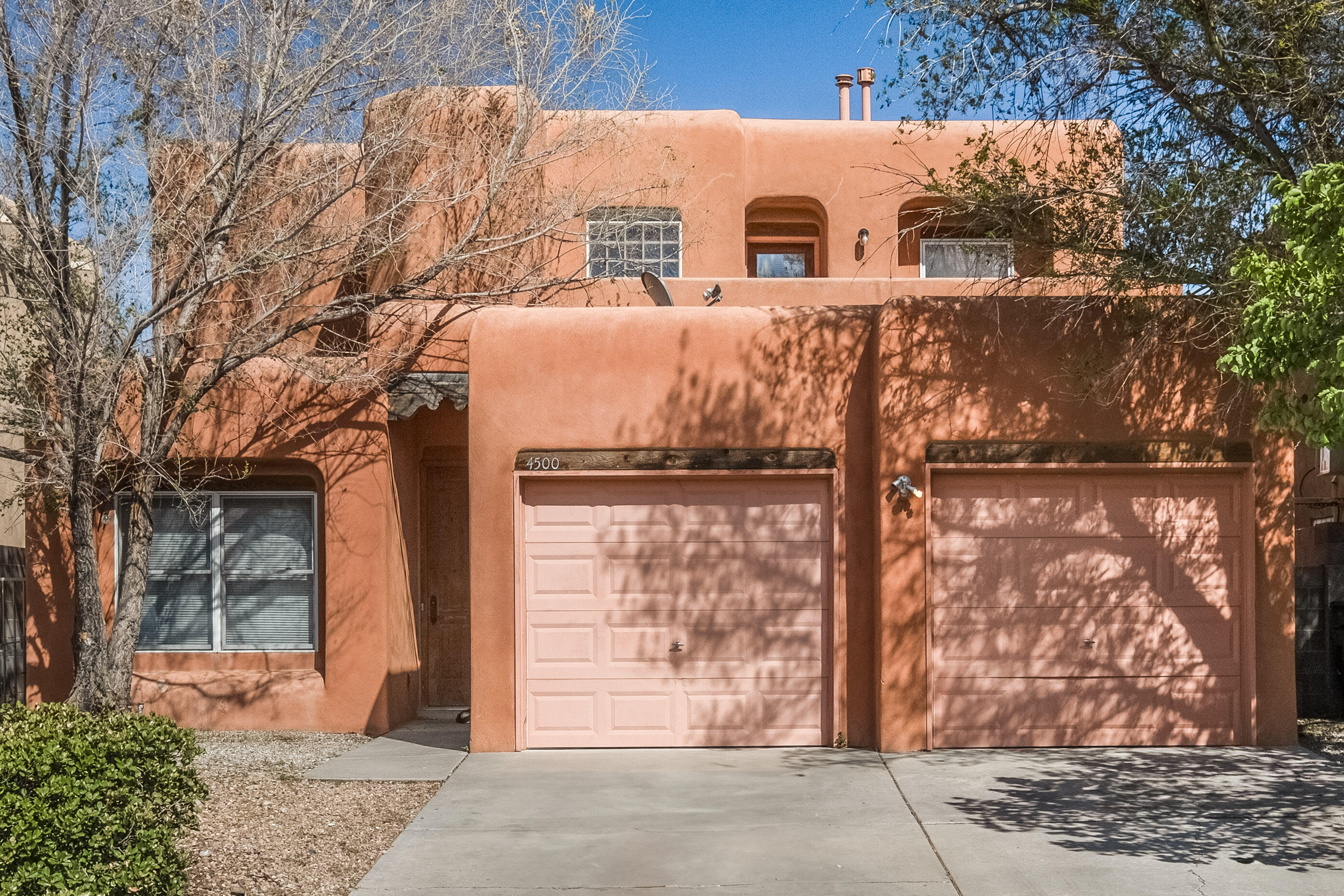 This home in neighbor to the Petroglyph National Monument! Primary suite with full bath and walk in closet downstairs. Living room with kiva fireplace Galley kitchen with breakfast nook and formal dining.  Two bedrooms upstairs, full bath, small balcony.Nice.
