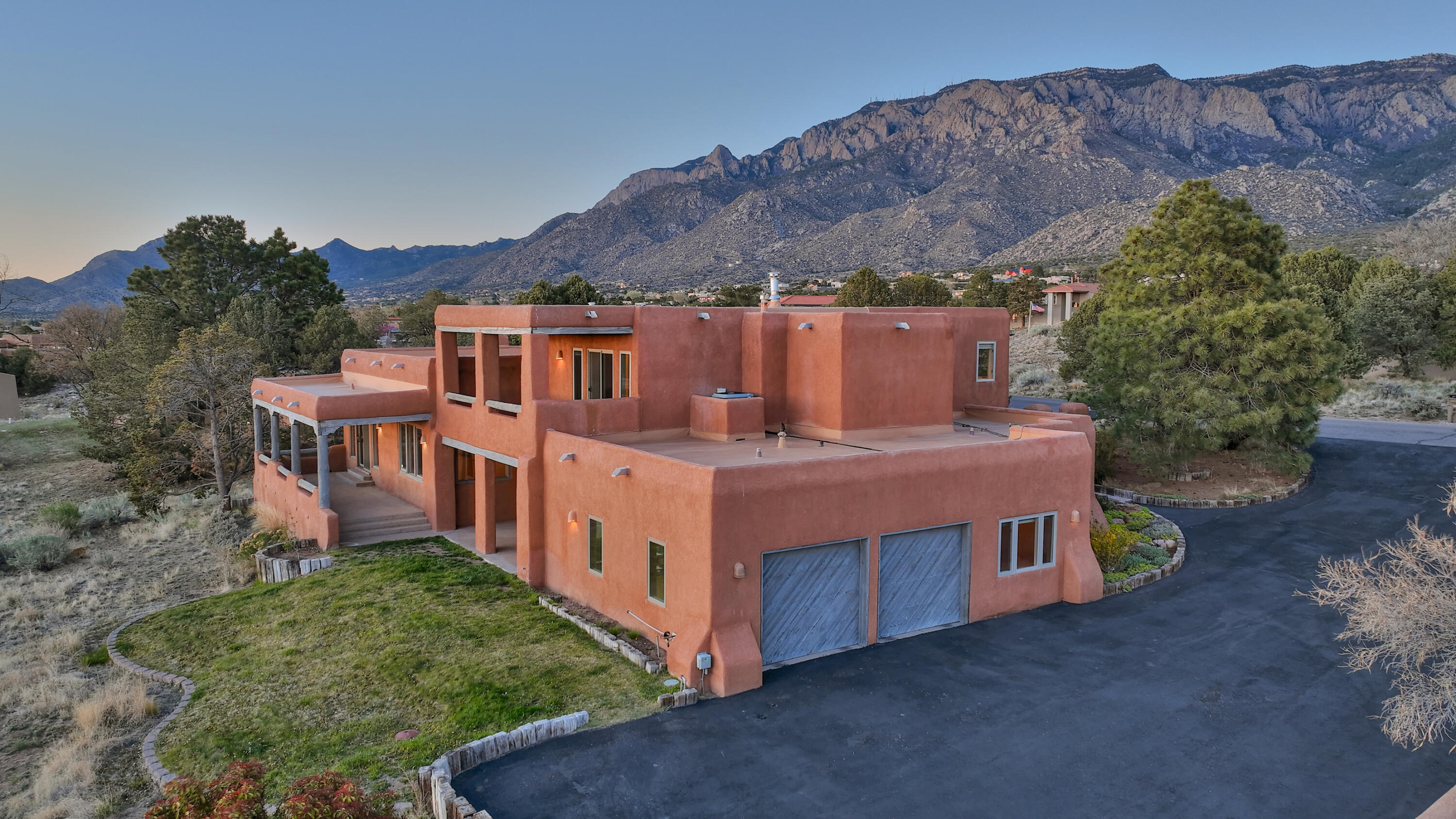 Welcome to this gorgeous New Mexican style hacienda.  Features include beautiful brick floors, vigas, niches, corbels, tongue-in-groove ceilings, antique candlelight sconces, and three kiva fireplaces.  The current owners have opened up the kitchen to the great room to create a bright, airy space.  The kitchen boasts SS appliances and granite countertops.  Enjoy amazing city views from the extensive covered porch in the backyard or while relaxing on the balcony off of the primary suite on the second floor.  If majestic mountain views are more your style, you will love the enclosed front patio, which is a true oasis with a fountain, grass, and an open patio.   Prepare to be impressed.  Located in desirable Sandia Heights, close to trails and with excellent public schools in the area.