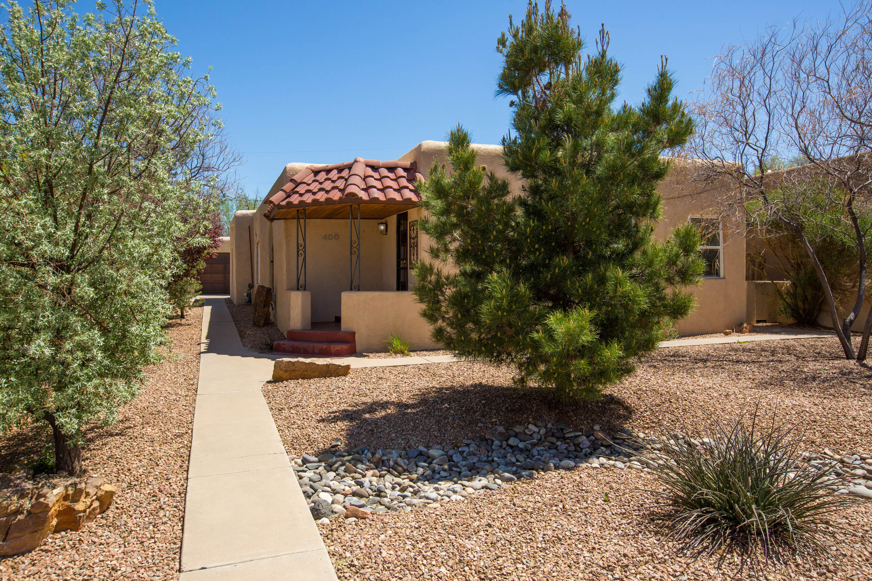 This home presents a wonderful opportunity to live in the heart of Nob Hill, within walking and biking distance to some of Albuquerque's best restaurants, breweries, boutique shops, and UNM. Enjoy the charm of yesteryear with beautiful hardwood floors, graceful arched windows, coved ceilings, and beautiful millwork. The flexible floor plan offers 2 bedrooms, with several rooms that could be converted to a third bedroom, 2 dining areas, a large utility room and 2 nicely appointed bathrooms. It also features a 2 car garage, rarely found in this area. TPO roof was installed in 2023! The backyard is a retreat with a covered patio and a beautiful water feature. The front yard is also beautifully landscaped and offers great curb appeal. Enjoy the convenience of this great location!