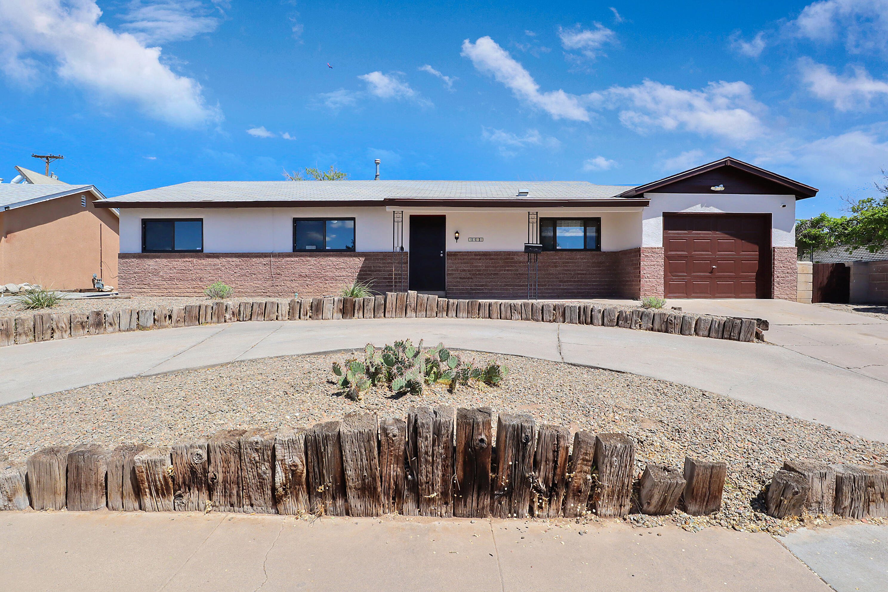 Discover this beautifully updated 3-bedroom, 2-bath home in Albuquerque, freshly painted inside and out. The residence features upgraded flooring in many areas, a modern kitchen with granite countertops, and renovated bathrooms with tile-surround showers. A unique double-sided fireplace connects the dining and living rooms, enhancing the cozy ambiance. Enjoy extra space with a large family room and an adjoining bonus room/sunroom. This home offers both a 1-car attached garage and a detached garage in the back, accessible through the side yard. This home has a perfect blend of comfort and convenience in a stunning setting!