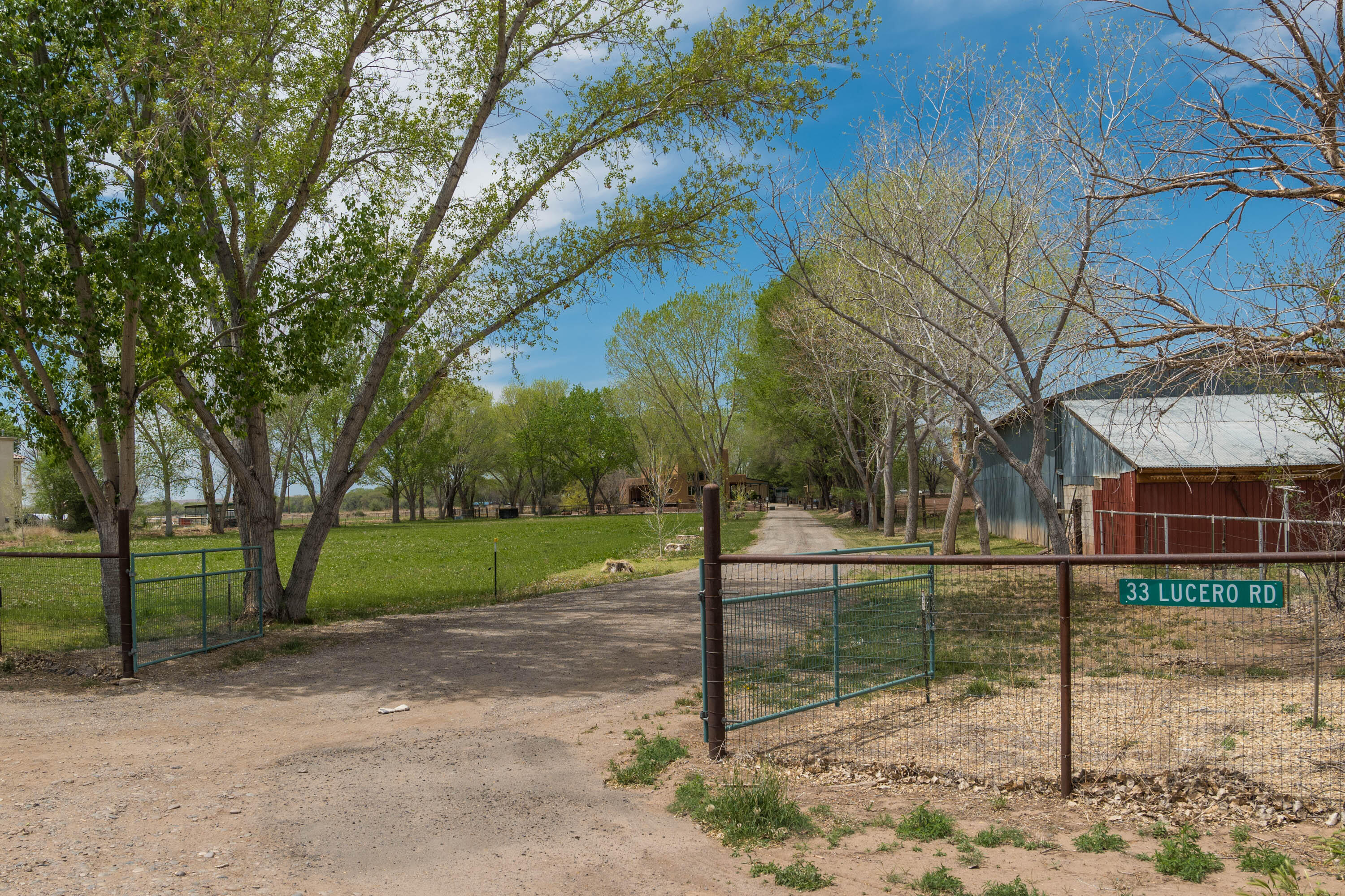 This incredible custom home is located in a beautiful pastoral country setting. Enjoy the privacy afforded with over 4 acres of space located directly next to an acequia. The entire property is fenced and gated. Canopies of mature trees and acres of lush pasture create a stunning entrance to this property. Upon entering the custom home, you will love the bright and open feel with soaring ceilings. Classic Southwestern charm abounds with beautiful wood ceilings with Vigas, 2 Kiva fireplaces, stained concrete floors, and beautiful custom cabinetry. The kitchen is beautifully appointed with rich granite and stainless steel appliances. There is a heated garage/workshop/casita not included in the square footage. Plenty of room for horses with stables in place. This is truly a great property!