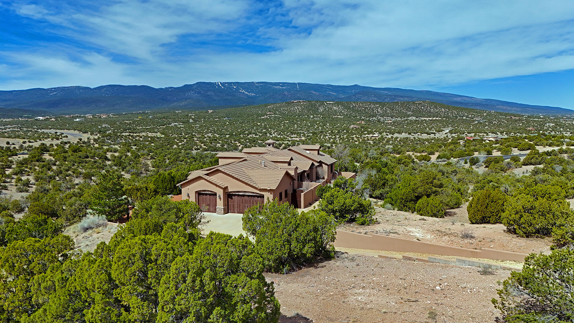 San Pedro Overlook @Campbell Ranch is a world apart. A world w/625 acres of protected nature preserve & spectacular NM East Mountain views. An active world with hiking & easy access to golf, skiing & biking provide an extraordinary lifestyle.  Custom unique features abound on this 3.3 acre property. 3 bedrooms + study, 2 large bathrooms w/steam shower & luxurious tub perfect for relaxing. Unobstructed  VIEWS from every window.A wrap around porch is perfect for taking in the views while enjoying morning coffee or an afternoon glass of wine in this peaceful setting.  Gourmet kitchen w/ Viking gas stove & more. Separate room off garage perfect for studio or theatre room. This community has none of the city's distractions, but all of its amenities, just minutes from ABQ or Santa Fe