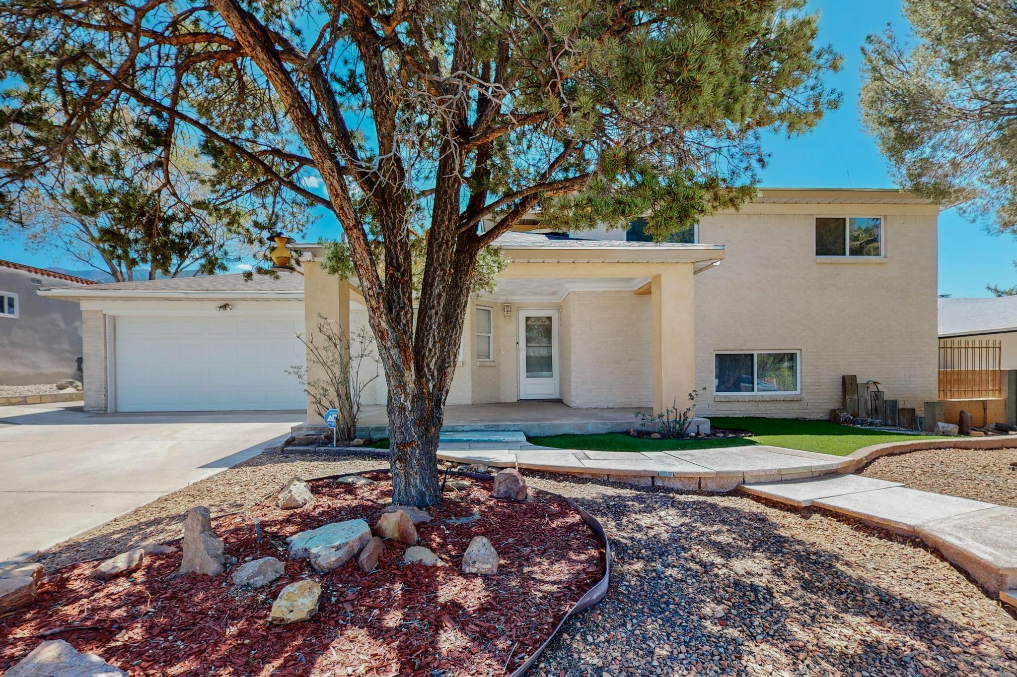Welcome to the highly desirable Far NE Heights area of Albuquerque.  This amazing custom home offers an incredible opportunity to live in a quiet neighborhood near popular shopping, excellent schools, parks, access to freeways and much more.  The front yard boasts a meticulously maintained custom walkway, mature vegetation and low maintenance beauty.  Natural shade for hot summer days!  Enter into a spacious living area, extra dining space and beautiful kitchen that is sure to impress.  You'll never bore of being at the kitchen sink with unobstructed mountain views! Backyard building is permitted (320 sq ft) and comes complete with a new roof, garage door access and climate control (heat + electric). Brand new roof (see LO/SO), new carpet, new paint and so much more to brag about!