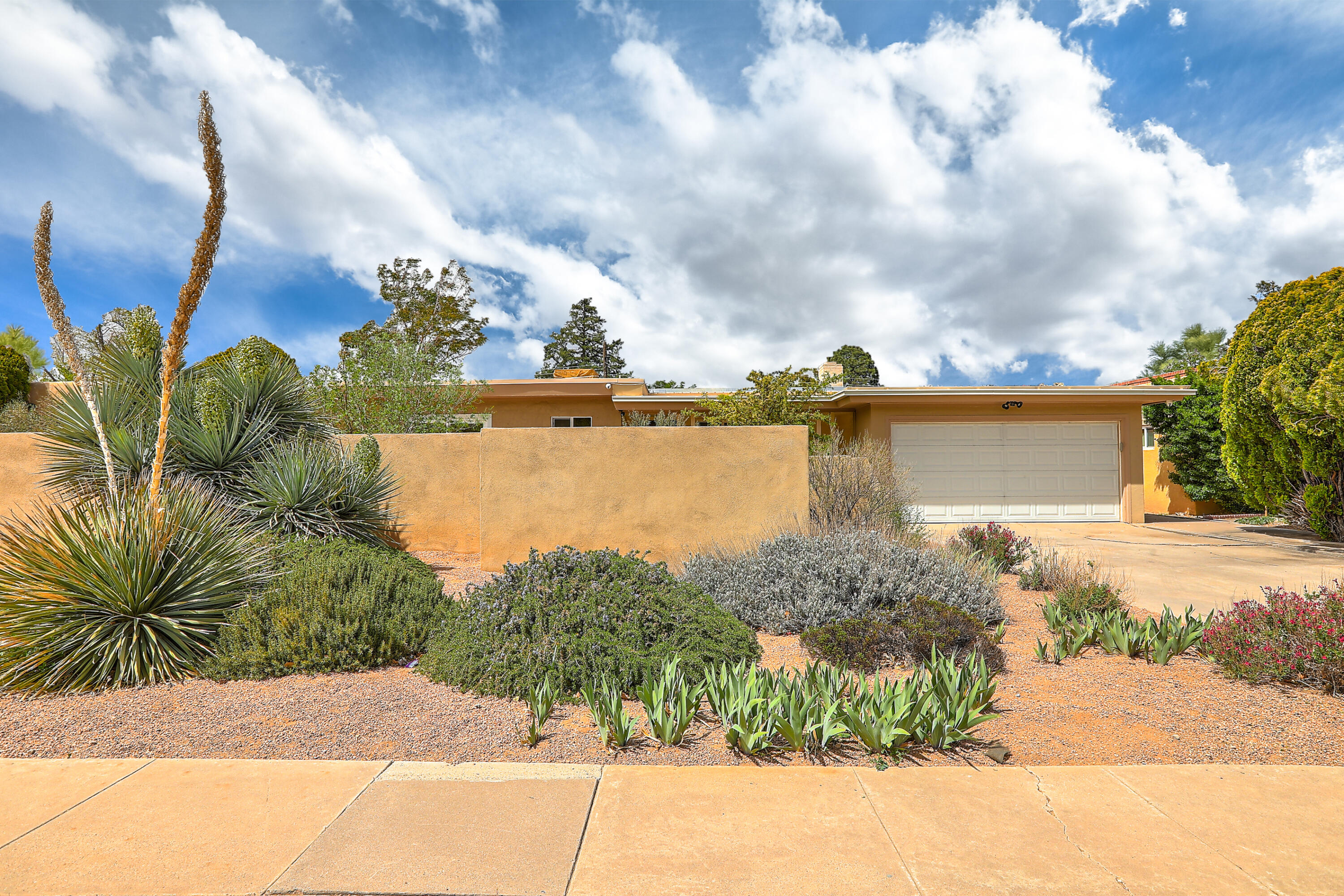 This is the one! Come see this lovely home located near UNM. Second-owner home, meticulously cared for. Notice the private courtyard as you make your way to the front door. Upon entrance, be impressed by the newly polished wood floors. The home offers a functional floor plan spanning 1,603 sf, 3 bed, 2 bath, a living space with a wood-burning fireplace, a cozy study area, and plenty of storage. Bedrooms have maple oak closet doors. The kitchen features a deep sink, gas stove, SS appliances, walk-in pantry, and maple oak cabinets. The master bedroom offers a peaceful retreat feel; step out to your very own private courtyard. New interior paint. A drip system is set for all your gardening needs. A high-end camera system conveys with the sale. Don't miss this one! Schedule a showing TODAY!