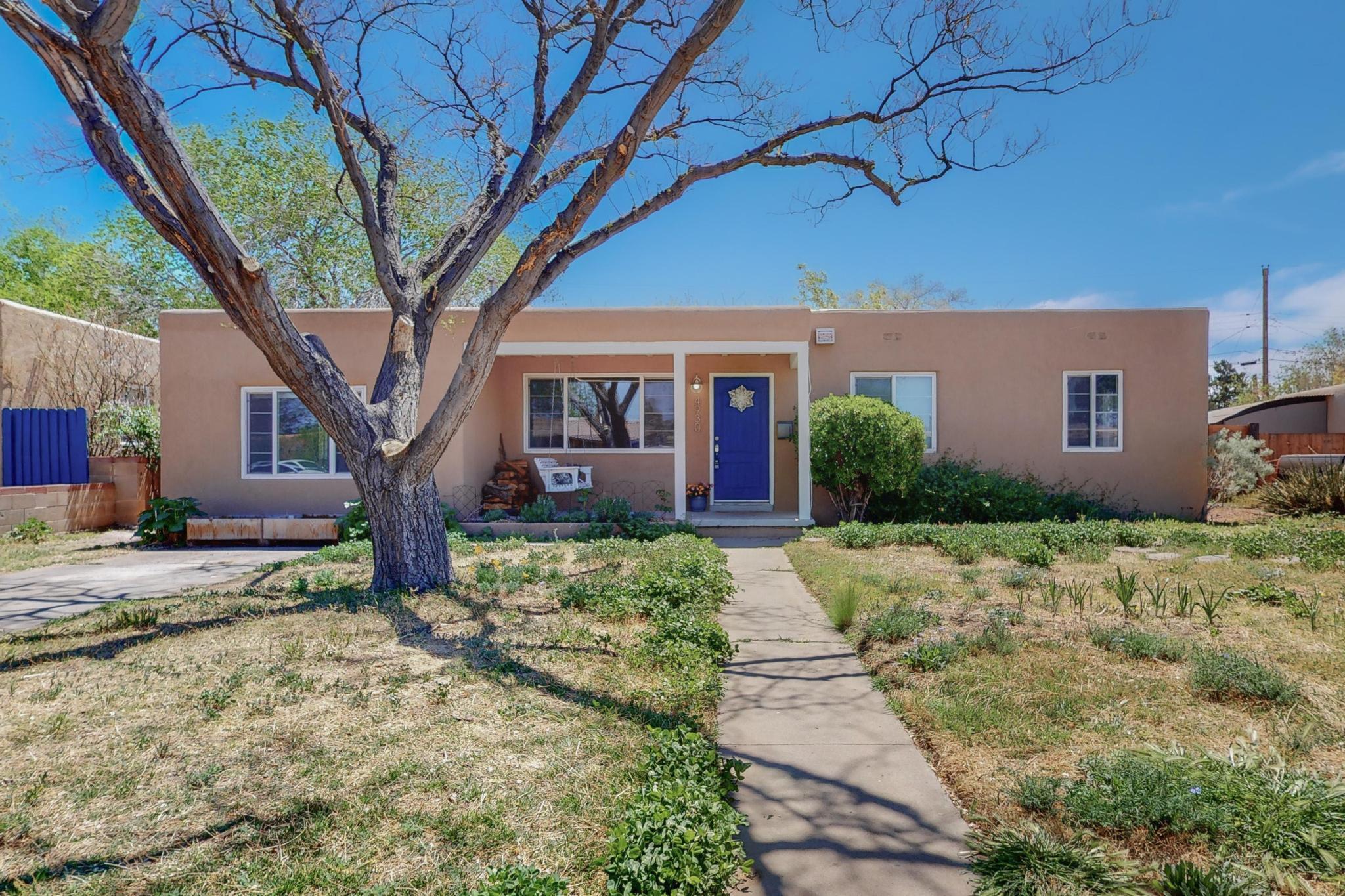 Welcome to this lovely S. UNM home! Inside you'll find hardwood, tile & laminate flooring, fresh paint, updated windows, curved archways, and plenty of room. Both bathrooms have been updated in the last 5 years. There are 2 living areas, 1 w/ a fireplace for cozy evenings, and 1 cold be used as an office. The owners used the large room in the back as their bedroom. Its also a  great space for a rec room, office, rental, or anything you imagine. Outside you'll find a  covered patio, large backyard and flowering locust, mimosa, & plums trees. Gate access on both sides leads you to the front yard where you'll find raised beds, amended garden soil and a lovely front porch complete with a swing. You might even find a carrot in the ground! Easy access to many places. Come see this one today!