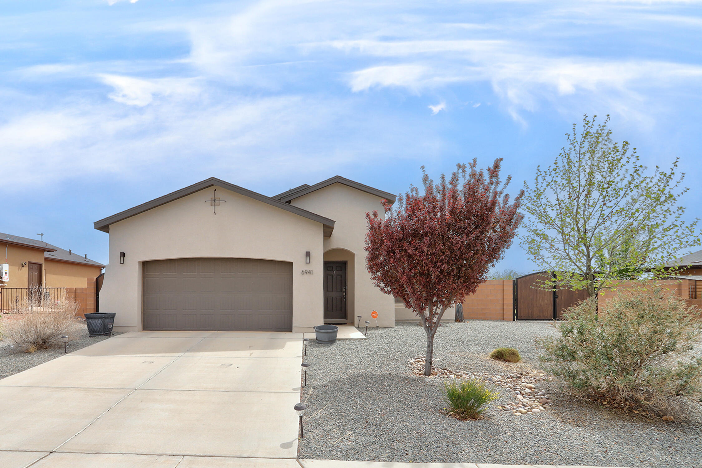 Discover this stunning single-story home built by Abrazo in 2018, located in the peaceful Mountain Hawk neighborhood of Rio Rancho. This modern 3-bedroom, 2-full bathrooms smart home is move-in ready with a walking closet in primary bedroom and a soak tub for added relaxation. Enjoy a spacious floor plan ideal for entertaining, a modern kitchen equipped w/gas stove, with a skylight and stainless appliances, and a fully insulated garage. The landscaped backyard features fruit trees, an irrigation system, and a raised privacy wall perfect for relaxation and entertaining. Side yard access accommodates your RV, boat, etc. No HOA/PID fees and easy access to Albuquerque and Santa Fe via HWY 550/I-25.