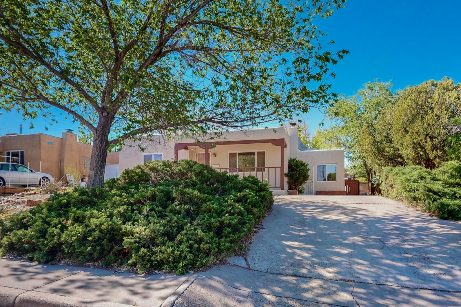 Classic Victory Hills Charmer! This cutie has a freshly updated exterior, and the bright and cheerful interior is ready for your personal touch. There are two living areas, making the space flexible and full of potential. Loads of original charm remains, like the original wooden floors and fireplace. The property features a TPO roof, a manageable yard, and thermal double-paned windows. Enjoy a friendly neighborhood vibe from the inviting front porch. Fall in love with this quintessential Albuquerque home!