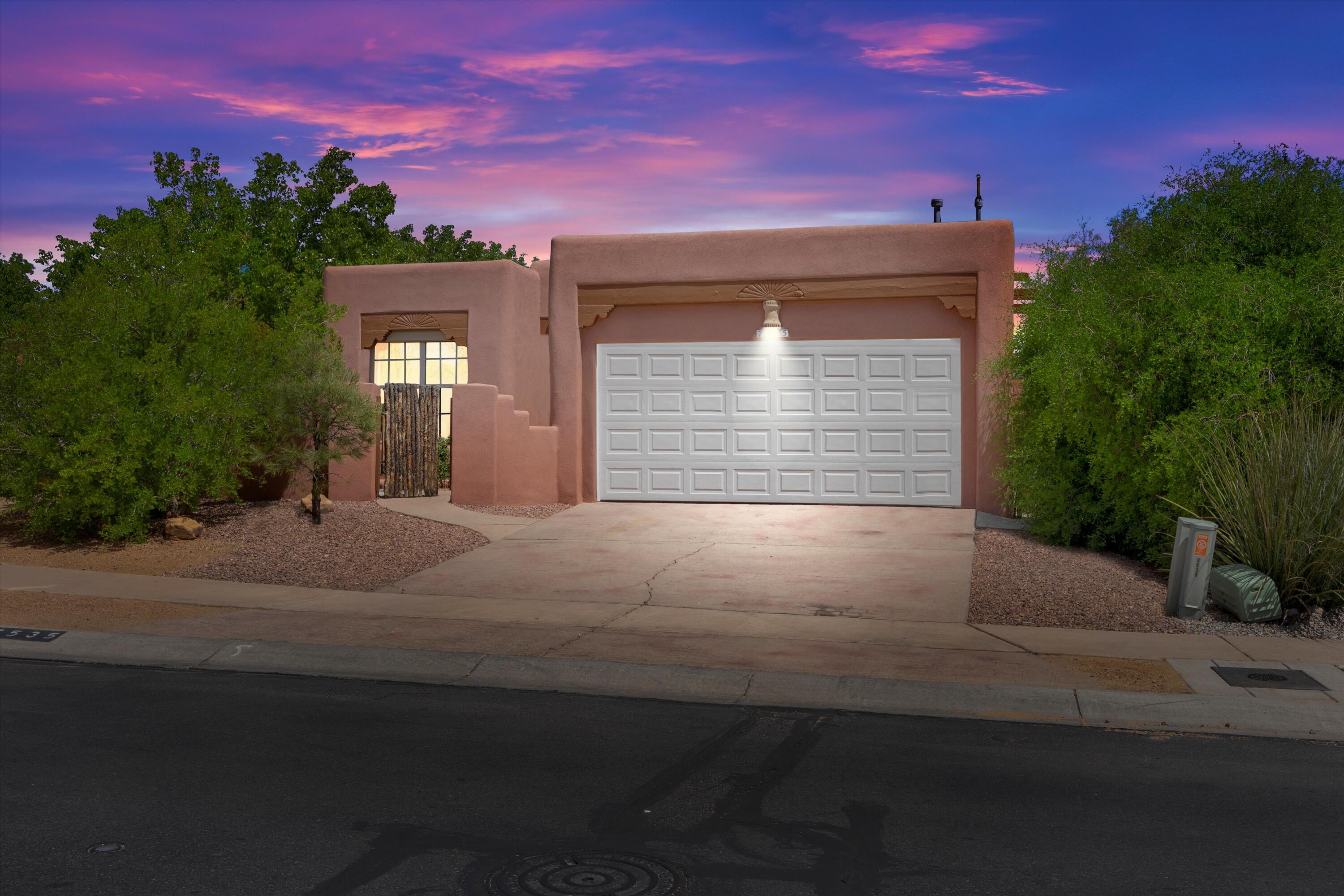 A Southwestern custom-style home in a gated community, nestled across a picturesque village park with a gazebo, BBQ area, rock waterfall, and pond. As you approach the home, a welcoming courtyard entry beckons, and the exterior facade reflects traditional Southwestern adobe architecture, boasting earthy tones and stucco walls that harmonize seamlessly with the surrounding landscape. The great room features a soaring ceiling with tongue and groove (T&G) detailing, complemented by rustic vigas. Nichos (recessed wall niches) are throughout the home.The centerpiece of the primary bedroom is a traditional kiva fireplace. A second kiva firplace graces the living area. Carved wooden posts and corbels accentuate doorways and architectural elements. (Refrigerated air conditioning.)