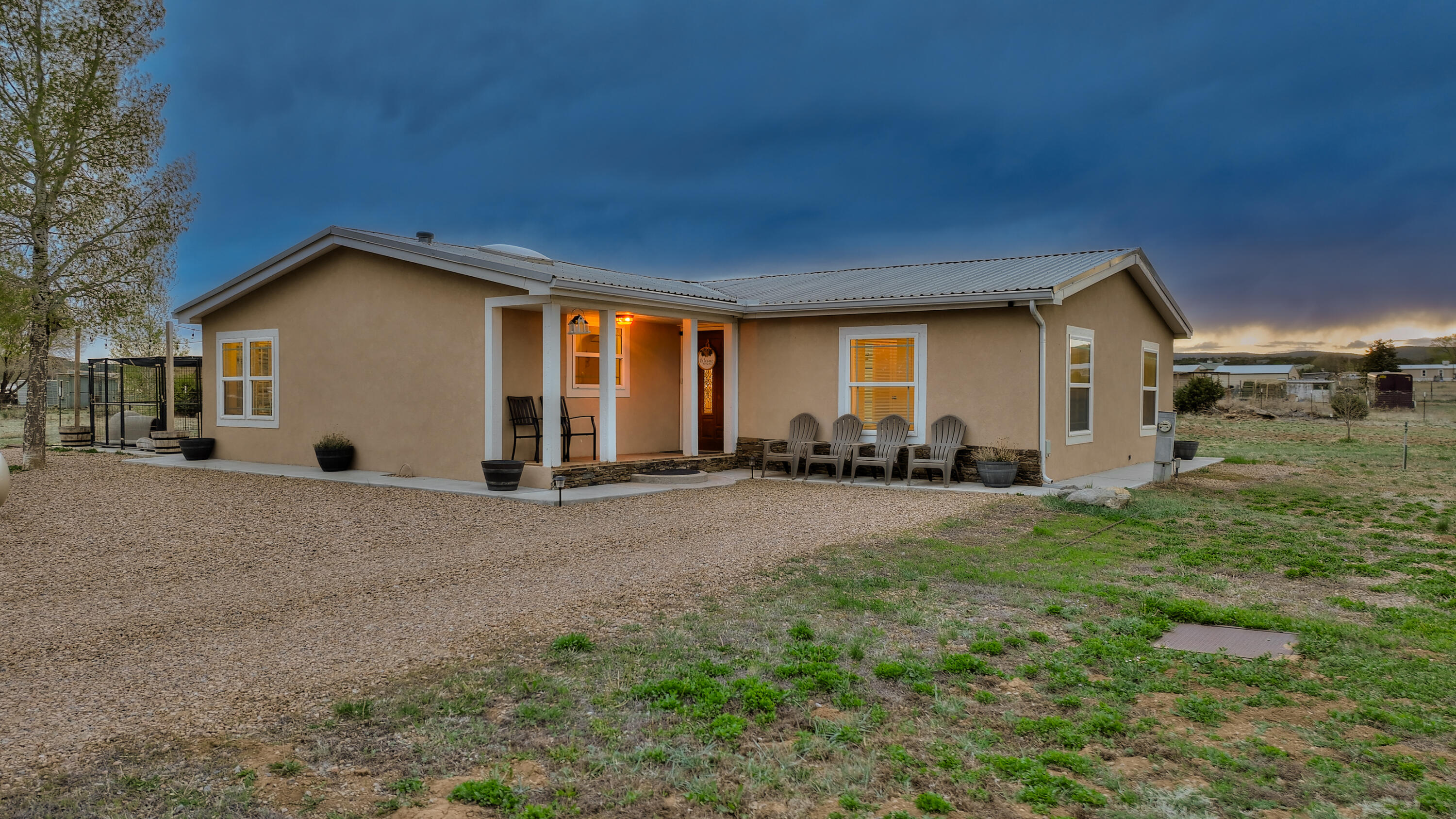 Discover country living at its finest! This charming property boasts 2.5 flat, usable acres, perfect for horse lovers. The property features a 25'x40' pro panel barn, with 220V power, offering ample storage or workshop space. Additionally, there is a two car port for covered parking.Experience modern comforts in this home, which has undergone nearly a complete remodel in the last three years. Updates include a refreshed kitchen, renovated bathrooms, and more, ensuring both style and functionality.Enjoy Entranosa community water, along with country gas propane and electric COOP services. Located just 0.5 miles from Route 66 Elementary. Plus, with Tramway a short 15-minute drive away, you'll have all the amenities of city life within reach.Don't miss out on this opportunity!