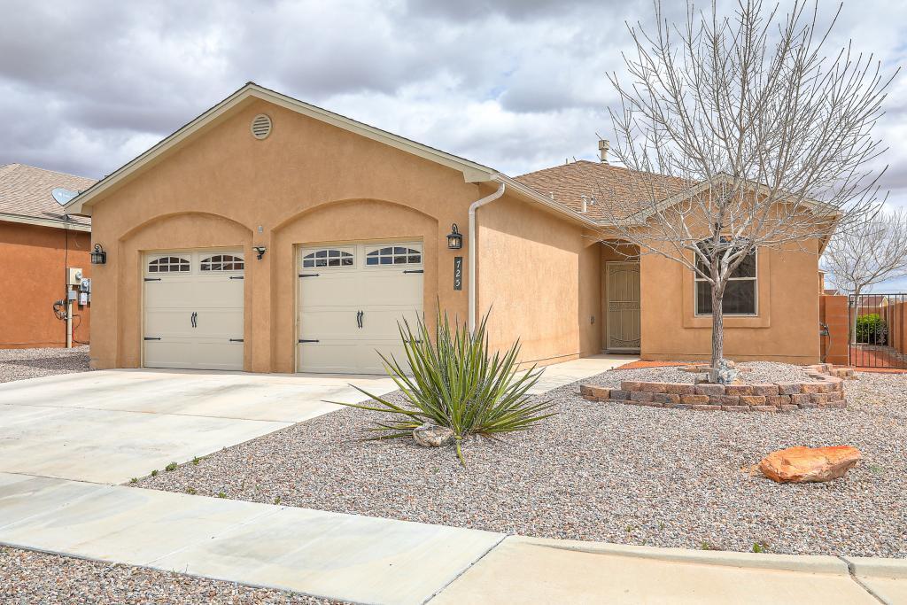 Custom home on a corner lot with a view of mountains to both east and west. Three bedrooms and three baths. Two master suites with walk-in closets in a quiet, well-lit/safe neighborhood. Assumable VA loan w/incredibly low-interest rate. Walk-in pantry off kitchen. Easy commute to Albuquerque. Mature landscaping with a large private patio, shade, and fruit trees. Lots of natural light with a semi-open floorplan and cathedral ceilings. The study/bonus room could be a fourth bedroom, game/hobby room, or studio. Easy-to-clean wood-look tile throughout and carpeted bedrooms. Granite countertops and custom cabinets. Fiber-optic high-speed internet is available. Storage shed in the back and a large garage with room for storage, deepfreeze, workbench, etc.
