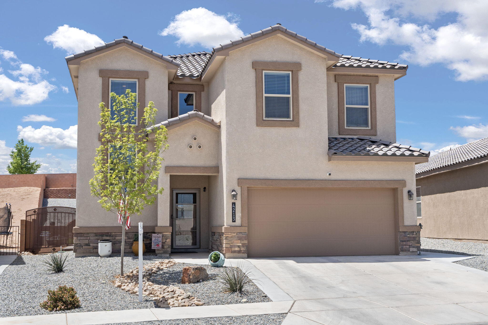 Welcome to this like-new Rio Rancho gem in the sought-after Cleveland Heights subdivision, a compelling alternative to new construction! This home features a modern open floorplan w/ wood-like tile & granite countertops. The kitchen boasts stainless appliances & a large island, perfect for gatherings. The main level includes a primary suite w/ dual sinks, large walk-in shower & a spacious closet. Enjoy an oversized pantry & ample storage, enhanced by ceiling fans & recessed lighting. Upstairs, a cozy loft offers space for a home office, play area or additional family room, leading to three additional bedrooms. Step outside to a beautifully landscaped backyard w/ $50K in enhancements, complete w/ a covered patio perfect for outdoor living & enjoying the mountain view! Call us today!!