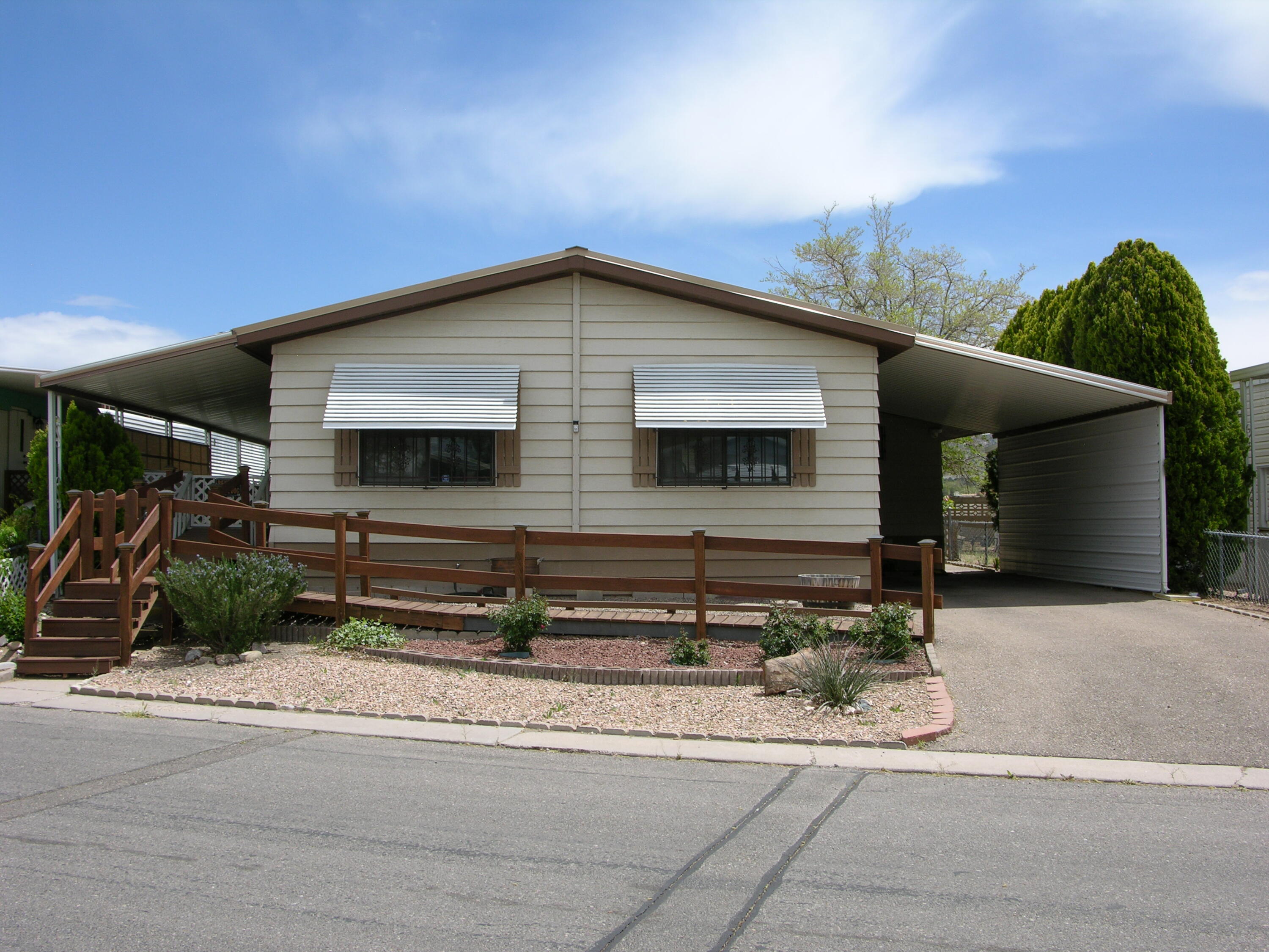 Affordable 3 bedroom 1 3/4 bath manufactured home that has been well cared for. Refrigerated air, updated kitchen with breakfast nook, living room with dining area, updated baths, cozy front and back porch's, small storage or workshop, and additional storage shed, metal roof, covered parking, and fantastic views from the backyard. Refrigerator, washer, and dryer included, and convey as-is. If you like swimming, there is a pool in the park for residents!