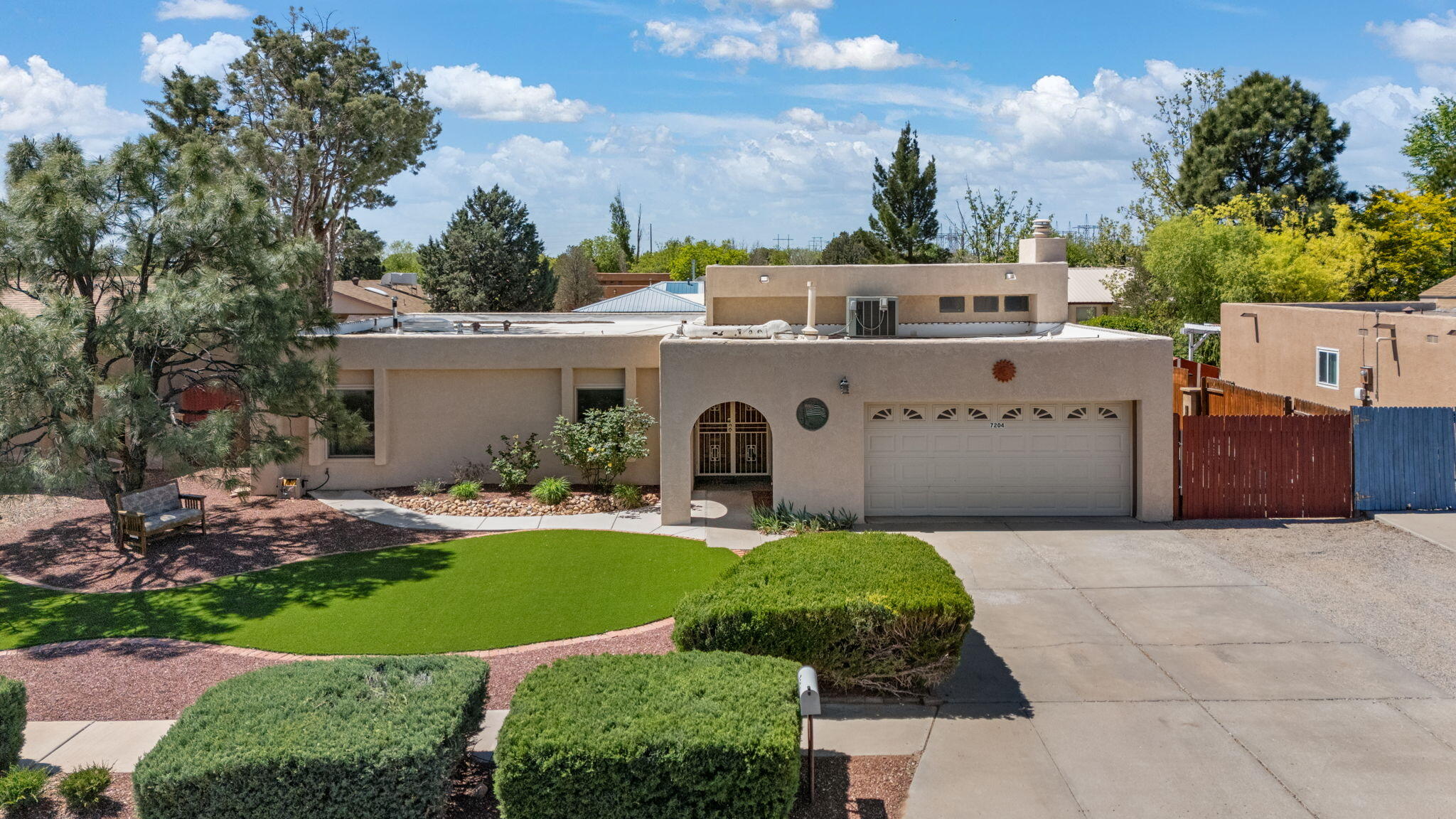 Nestled on a quiet cul-de-sac near Ladera Golf Course, this single-story home is freshly landscaped & full of custom wood details! NO HOA! Hand carved wood front doors lead you into Pueblo style home that features hard wood floors with 2 living spaces. 3 Bedrooms are great size and primary bedroom includes an updated en-suite with walk-in shower + custom vanity. Front living room is amplified with fireplace, clearstory windows, and beamed raised ceilings! Kitchen includes stainless steel appliances, granite countertops, island seating and open to large cedar wood family room! The backyard is ready for entrainment and enjoying the summer days, covered wood pergola, turf, new gravel, and fresh greenery. Seller has owned and cared for home for over 25 years! Roof was installed in 2019 - TPO!