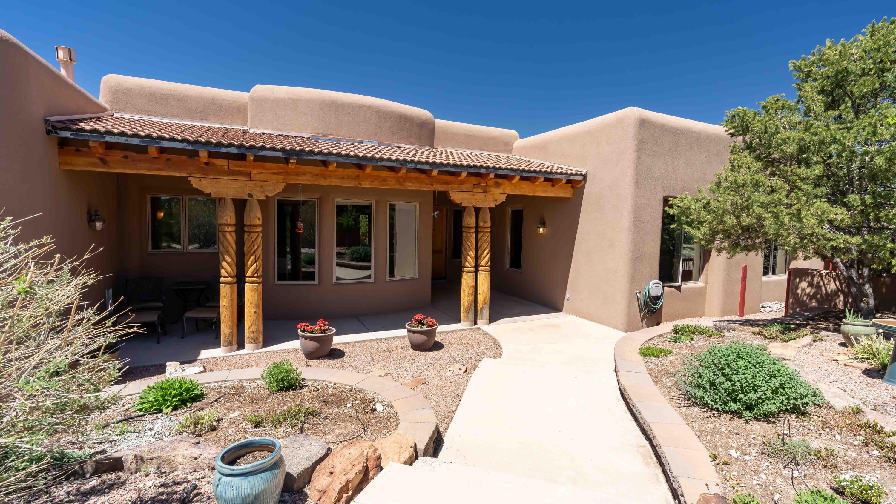 Open house Sun, 5/5, 1-4pm. Experience the charm of this stunning southwestern home located on a private 10-acre estate with breathtaking views of the Sandia Mtns. As you enter the courtyard, you are greeted by a spacious great room featuring beamed ceilings, wood accents, and cozy kiva fireplace. Custom upgraded cabinets in the kitchen & bathrooms add elegance to this beautiful home. This well-designed property boasts 3 good-sized bedrooms as well as a separate office for those who work from home. The primary bedroom features a kiva fireplace, perfect for cozy nights in. Outside, you will find a 3-car garage for your storage needs, a wood shed & dog run. Plenty of space for outdoor activities. Discover the beauty & tranquility of this one-of-a-kind southwestern oasis.
