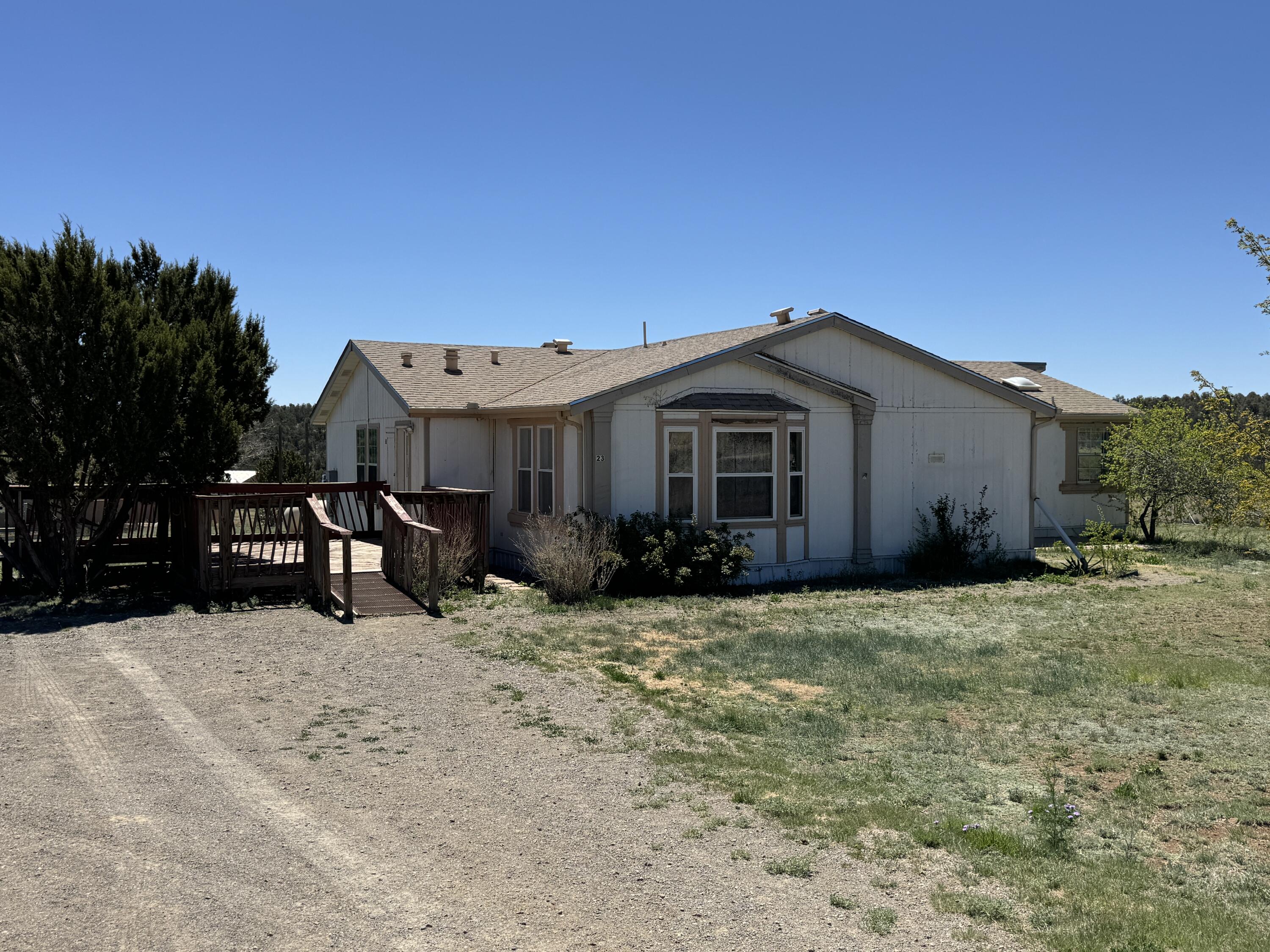 Move in ready on over 1.5 fenced acres. Doublewide plus! Factory built 13x28 section gives that extra sq ft you need. Tape/ texture. skylights and clerestory Windows. Separate laundry, walkin closets. 2880 watts solar systems saves on your electric bills. Completely fenced with locked gate