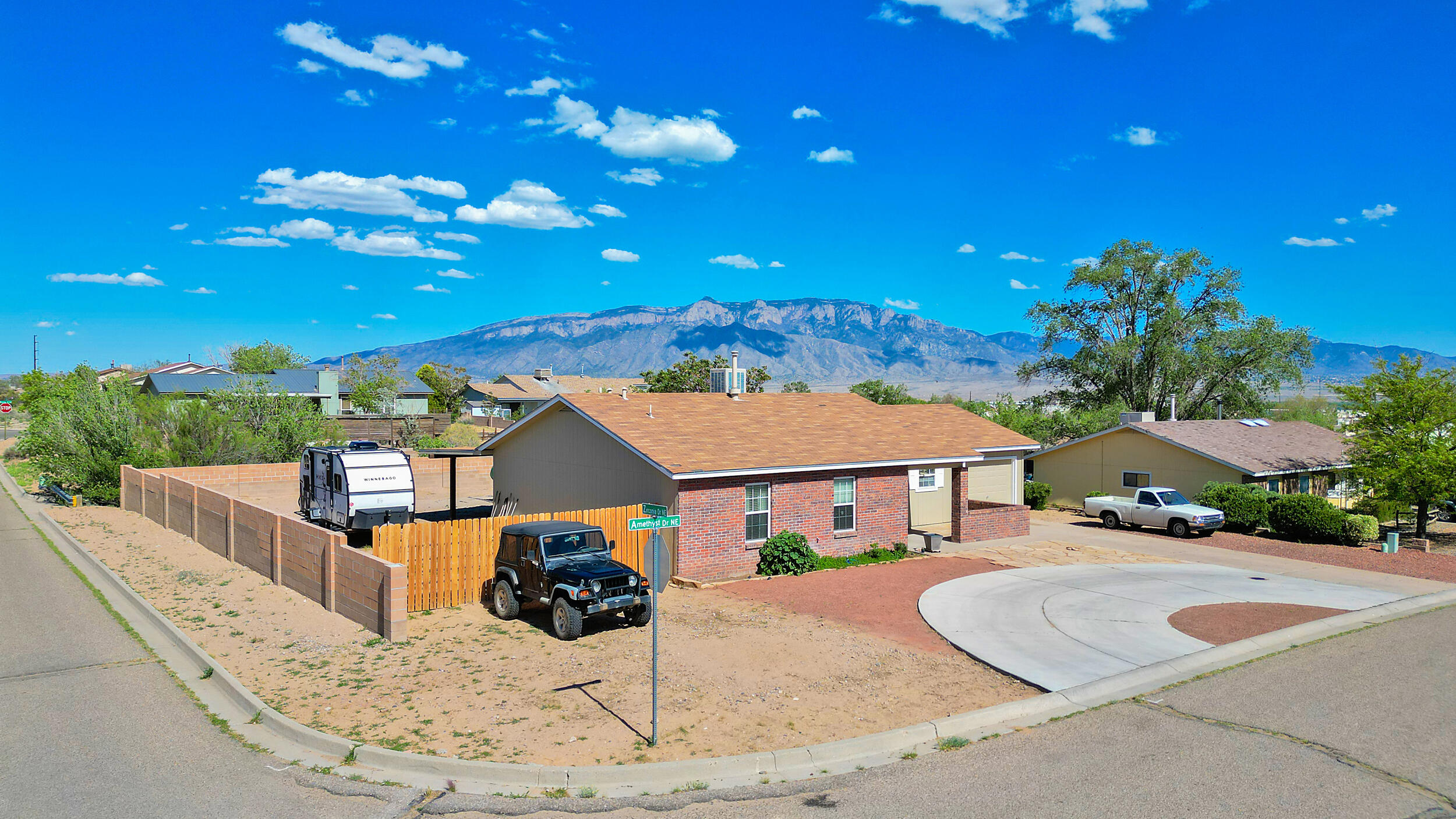 Warn and inviting, this home welcomes you in.  Outside, watch your kiddos play in the large yard or simply enjoy the mountain views while sitting on the covered patio that stretches the length of the back of the home.  The backyard gate access allows room to park your camper and all the toys.  Inside you will find the kitchen with all appliances, the dining and living area w/engineered hard wood floor and open to the back patio.  The Primary has a modern sink area.  The home sits on a corner lot with a green area running behind.