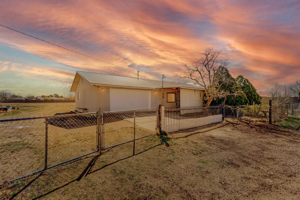 Step into serene living with this charming 3-bedroom, 1-bath home nestled on 1.25 expansive, flat acres at 4 Hendrix LN, Los Lunas NM. Enjoy the luxury of space with an oversized detached garage, perfect for all your hobbies and storage needs. Delight in the convenience of a private well, ensuring consistent access to fresh water. A pro panel metal roof is sure to please. The home was re-stuccoed in 2022. With both attached and detached garages, you'll have ample room for vehicles and projects. Don't miss this opportunity to own a piece of tranquility. Schedule a viewing today and embrace the joy of country living!