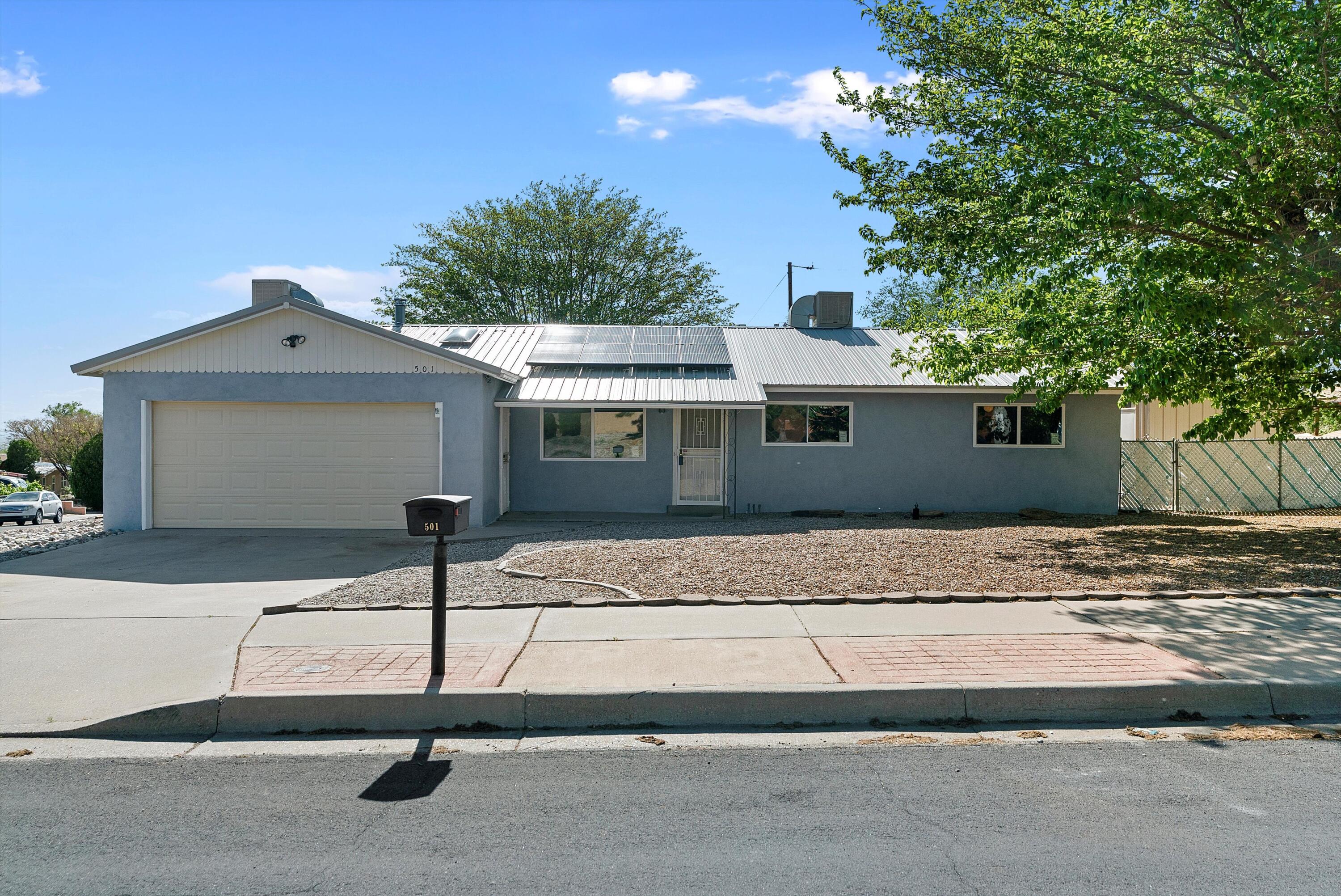 Nestled in the enchanting heights near the majestic Sandia Mountains, this delightful three-bedroom home is a haven of modern comfort and timeless charm. Step inside to discover a recently remodeled kitchen, a culinary masterpiece adorned with sleek countertops and newer appliances that elevate every cooking experience.Embrace the serenity of outdoor living in the expansive fenced backyard, the wall adds a touch of privacy and endless opportunity for landscaping. As you bask in the sun-drenched ambiance, take comfort in knowing that this home boasts not only modern kitchen appliances but also a solar system, promising eco-friendly living and reduced utility bills.With a durable metal roof overhead, worry less and enjoy more of life's precious moments.