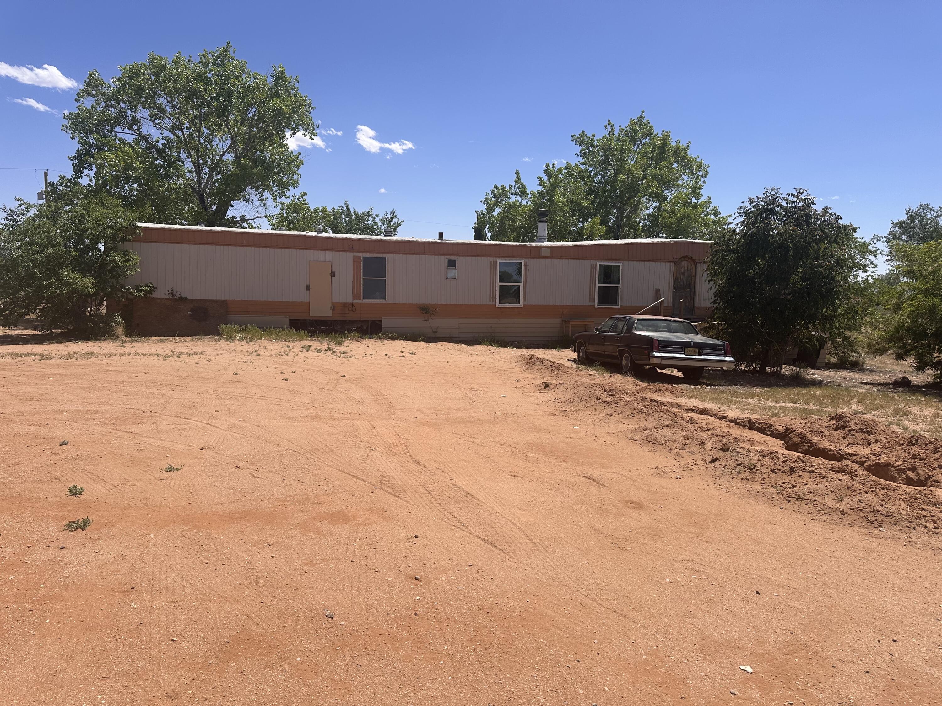 Great potential in this property. Investor special.  Property includes 1.35 acres with large workshop/Garage 40' x 34'.  Workshop is stick built on concrete pad with metal roof. Manufactured home needs work, but can be replaced or remodeled.