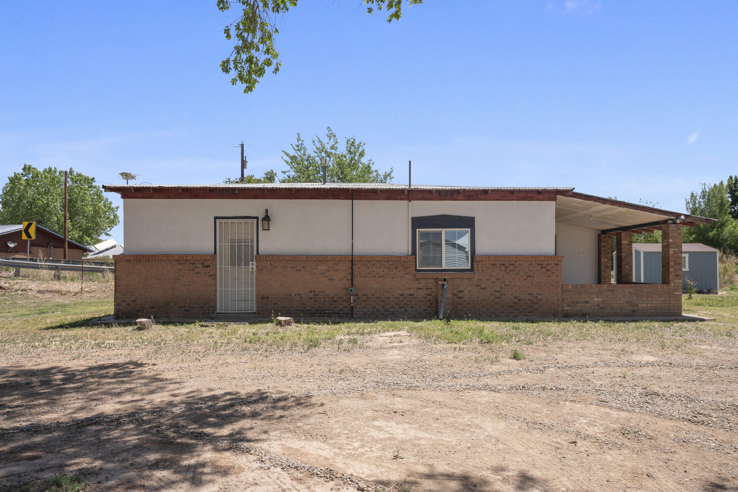 Take a look at this quaint adobe home on almost an acre and fully fenced in with a garden shed. It has great views all around and is nestled in a farming community. Inside you will find tile floors throughout with a recently refreshed kitchen. There are so many possibilities for this property. This home is waiting for you to call your own!