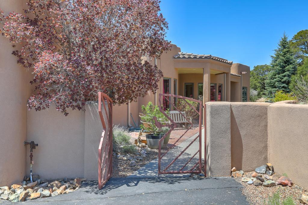 Large (3745 SF), custom built, very private 1-story home, close to I-40; quick commute to ABQ. Attached 3-car garage (876 SF) & detached shop/RV garage (750 SF). Large living room with adjoining passive solar dining/family room. Kitchen designed for entertaining; granite countertops. Oversized master bedroom/walk-in closet. All bedroom closets have built in drawers, shelving and clothes rods. Remodeled guest walk-in shower. Buried 1,000 gal propane tank. Paved drive with privacy gate, plentiful parking. Lot 3 acres in pinon/juniper woodlands. Mountain views. Natural landscaping. Walled courtyard/backyard; covered outdoor dog kennel. New silicone roof on home/attached garage & shop/rv garage with transferrable 50 year warranty. Buyer must join Woodlands Sewer Coop and HOA.