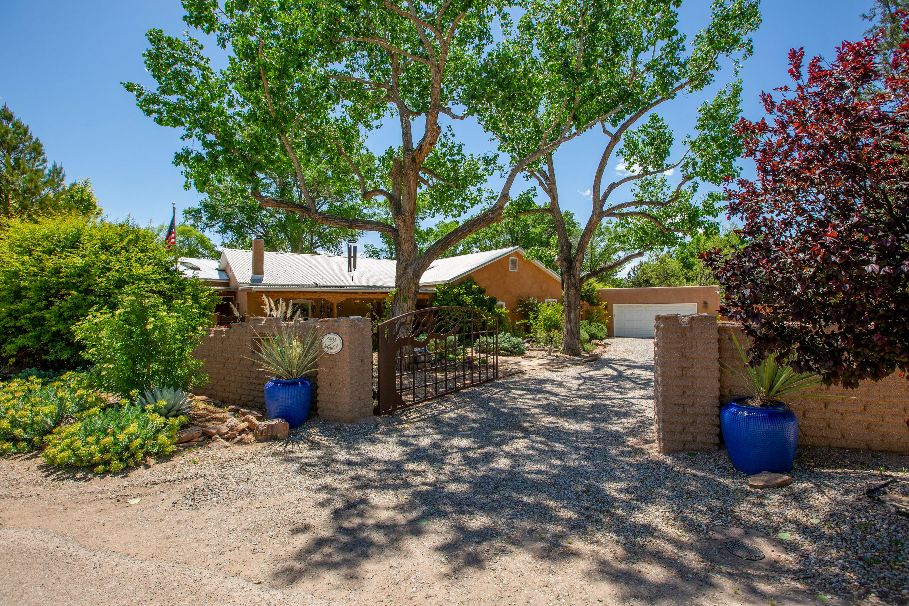 A North Valley oasis complete with stunning Northern NM architecture, beautiful gardens and a saltwater pool with cabana. This home has been lovingly maintained throughout the years. Originally, the Terrone adobe was built in 1901 and added onto over the years. A major remodel was done in 2015 adding gorgeous light filled rooms and connecting the guest house to the main house. Lovely patios abound and the entire property is walled for extreme privacy. Four fireplaces, wood beamed ceilings, stained concrete, and ceramic barn wood floors add to the ambiance and enhance the home's livability. 4-5 bedrooms and an office provide the space for gracious living. The incredible kitchen has 2 refrigerators, 2 dishwashers, and two ovens, custom cabinetry and, a large quartz island. Large pantry.