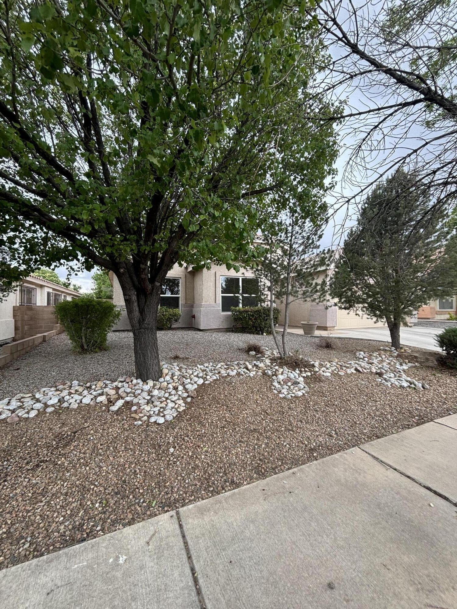 Welcome to your new  eco-friendly home in a quiet, lovely neighborhood on the West Side. Practically next door to the Petroglyph National Monument, this home has an updated backsplash, sink, overhead vent, and resurfaced countertops. The home features 3 bedrooms and a generous sized office/study, plus 2+ living areas. This beautifully landscaped house is elegant and well cared-for by the owners. And as an added bonus, enjoy the low electric bills because of the solar panels! Come and take a look at this gem.