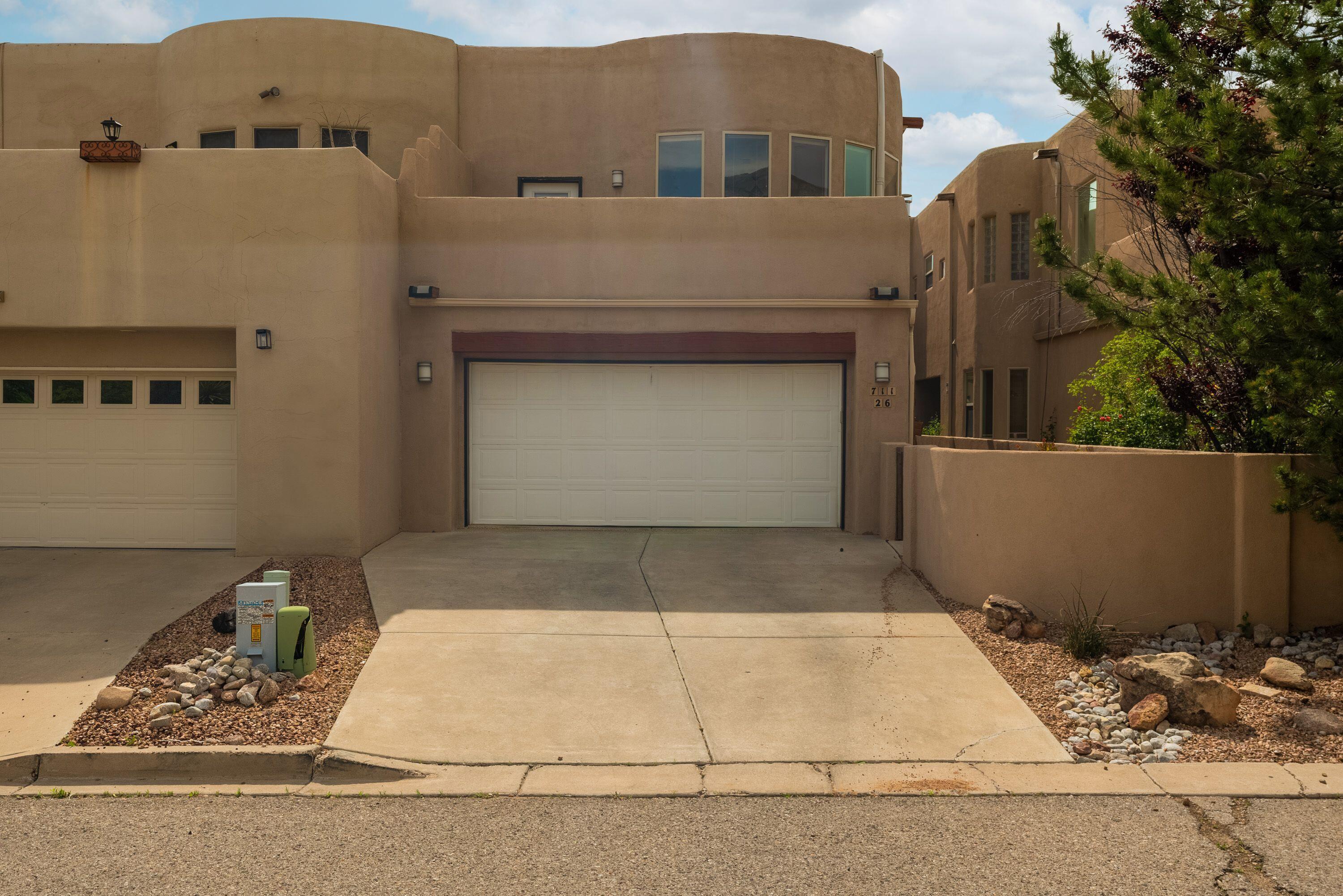 Exceptional Sandia Heights townhome.   The spacious living area greets you with large windows that frame the Sandia Mountains. Plenty of natural light throughout the home provides a light open feeling.  The Primary bedroom located on the upper floor has a balcony with amazing views of the city.   There are many special features include: a Smart Home with over 20 components such as switches, outlets, and fireplaces that can be programmed & voice activated with Alexa or similar.  This home also has a small elevator to carry your food and goods upstairs from the laundry room.  This is a must see.