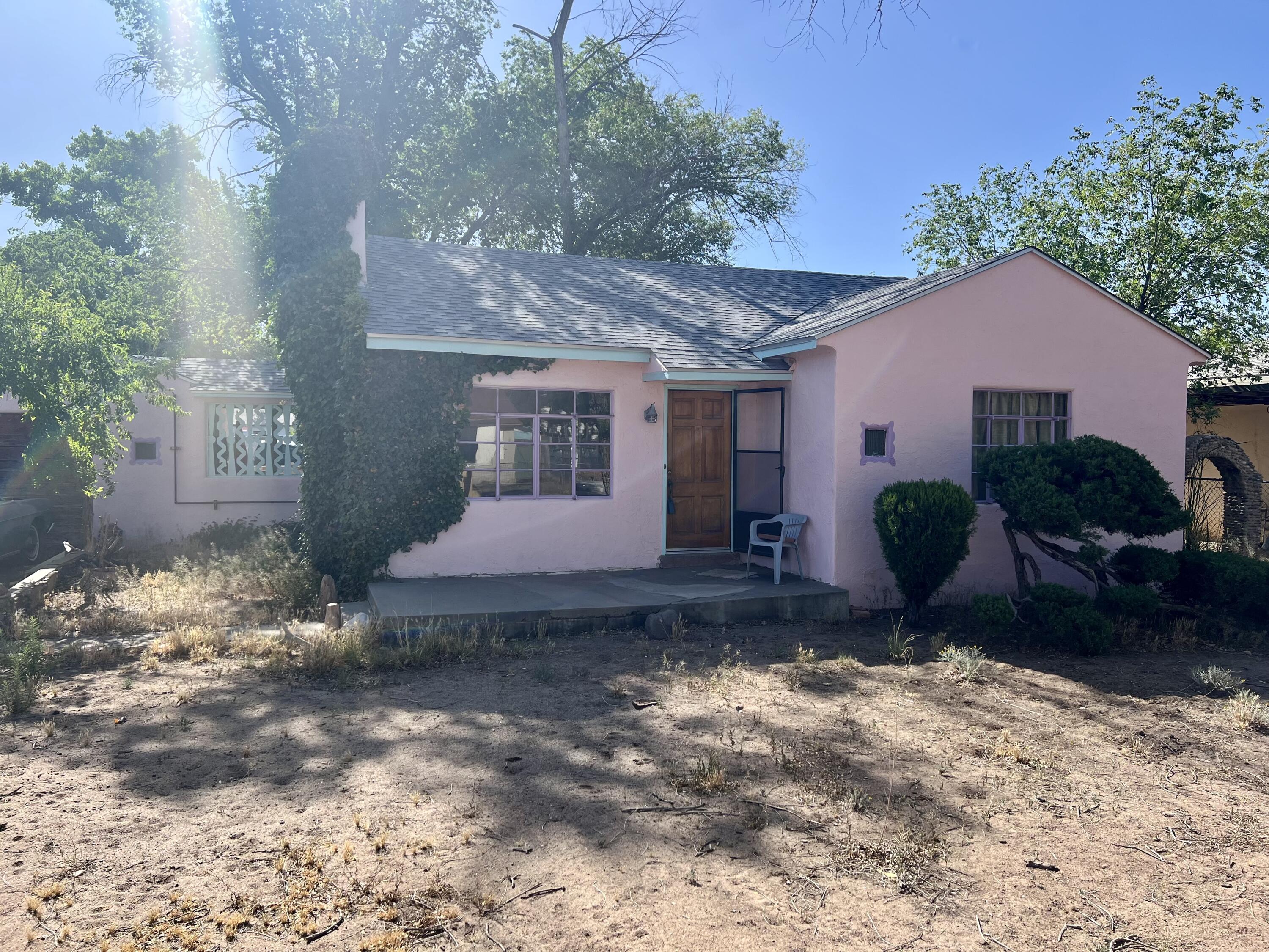 Well maintained classic home in the heart of La Vega Acres. Built in 1940, this 2 bedroom gem has stood the test of time. Great size lot at 1/3 acre with side yard access. New roof 2019. Gas log fireplace and wood burning stove. Original hardwood floors and cove ceilings. Beautiful big cottonwood trees and vines on property. Conveniently located near restaurants, grocery, UNM, hospitals, etc.