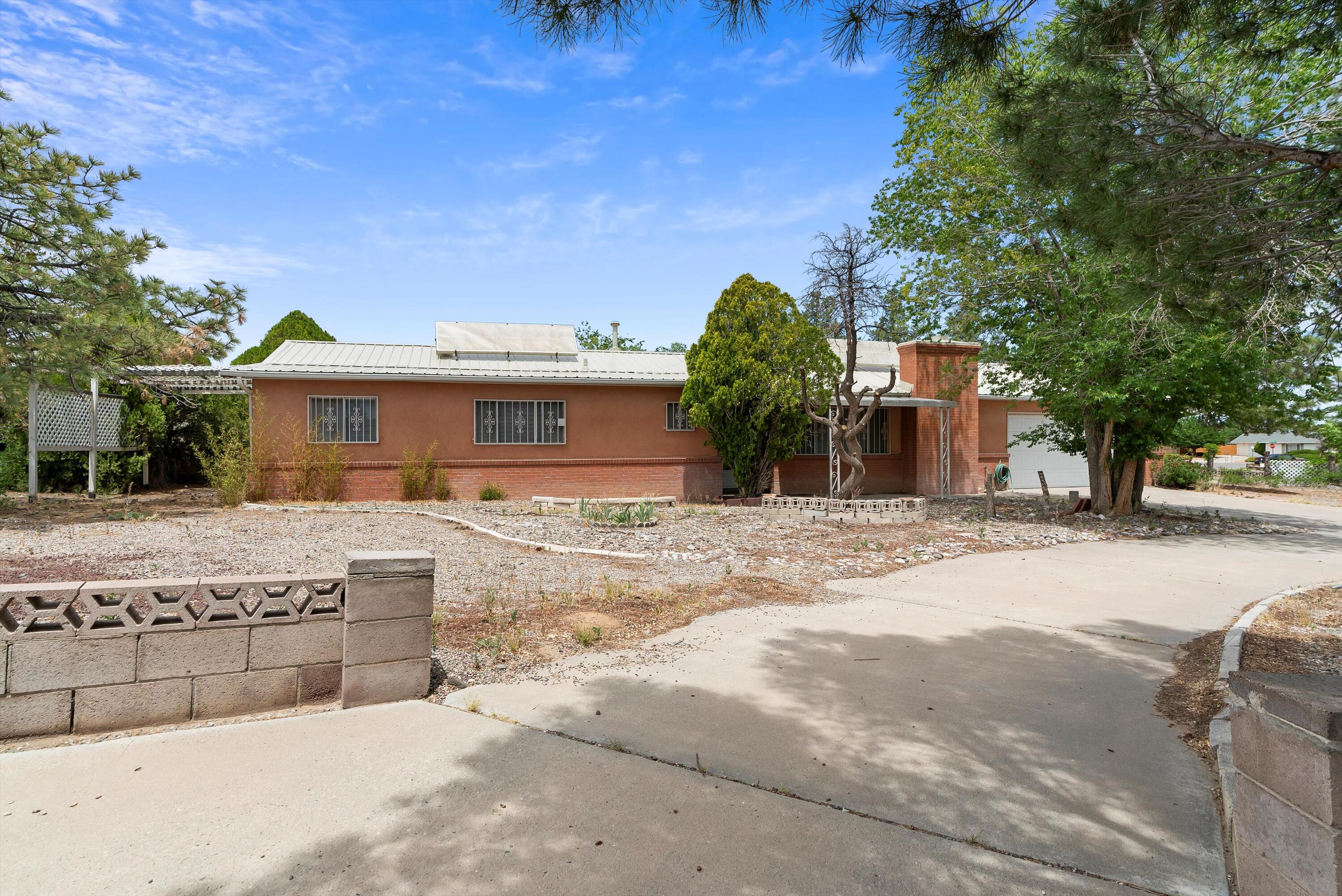 Well built home in the heart of Corrales Heights.  Featuring refrigerated air, granite counter tops, and a metal roof!  Situated on a large corner lot, with 3 additional storage sheds, and back yard access possible. No HOA! This home will not last long!