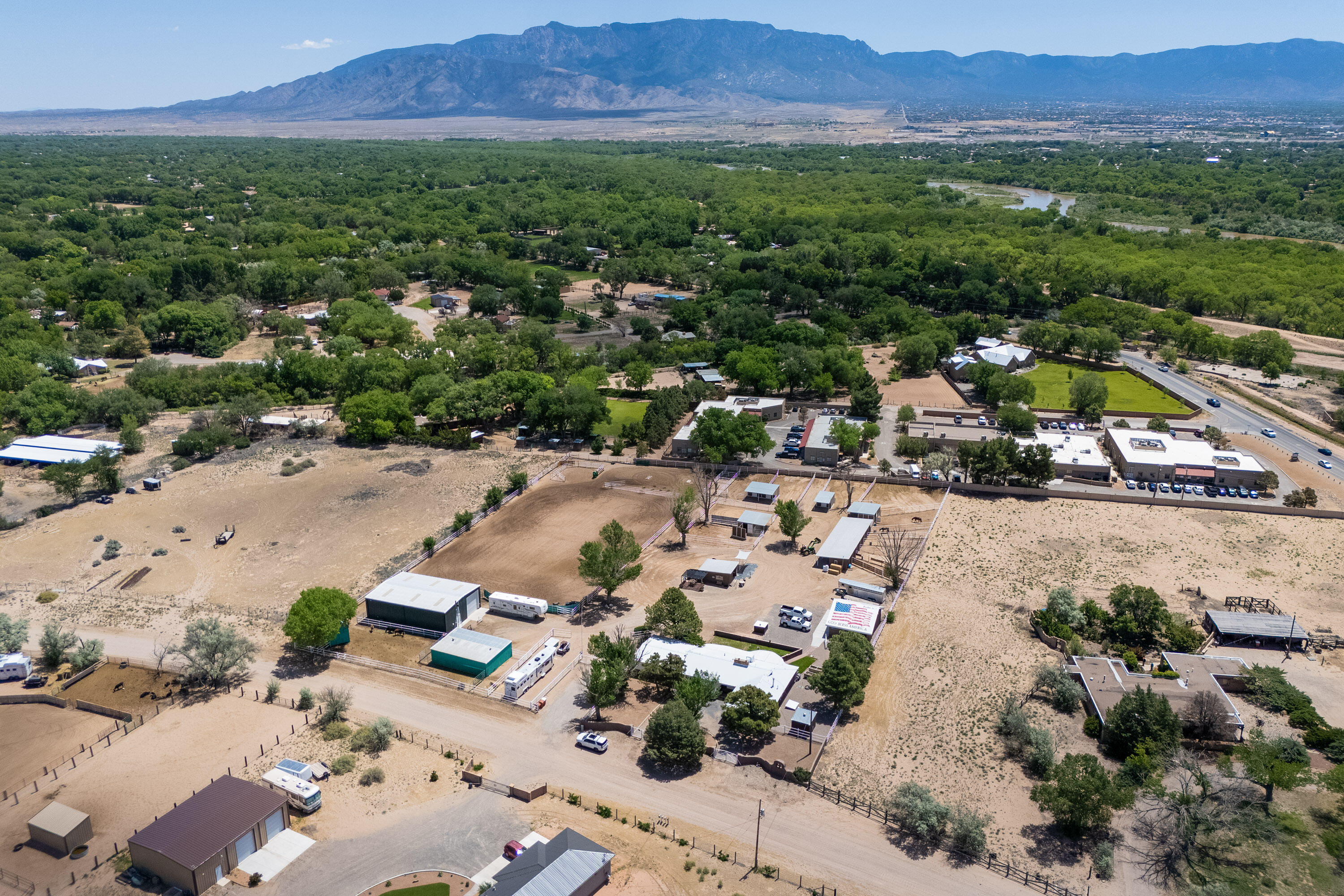 ***Premier Corrales Horse Property*** This fully pipe fenced & gated 3.2 acre ranch features 2122 sq ft home, 41 X 60 heated/cooled metal workshop/office/RV garage, 12 horse stalls/runs w/water & electric, 2 tack rooms, roping arena w/sprinkler system, A-Frame outbuilding w/loft, 3-car detached garage/storage, generator house, private well + 3 irrigation wells/windmill. Main house features remodeled primary suite w/rainfall shower (plumbed for steamer), radiant heat floor, beam ceilings, remodeled guest bath, wood burning fireplace w/indoor grill. Large, covered patio overlooking the horse facilities & Sandia Mountains. Prime location on the south end of Corrales with direct access to riding trails leading out to the Rio Grande, Corrales Bosque Preserve and yet minutes to city amenities.