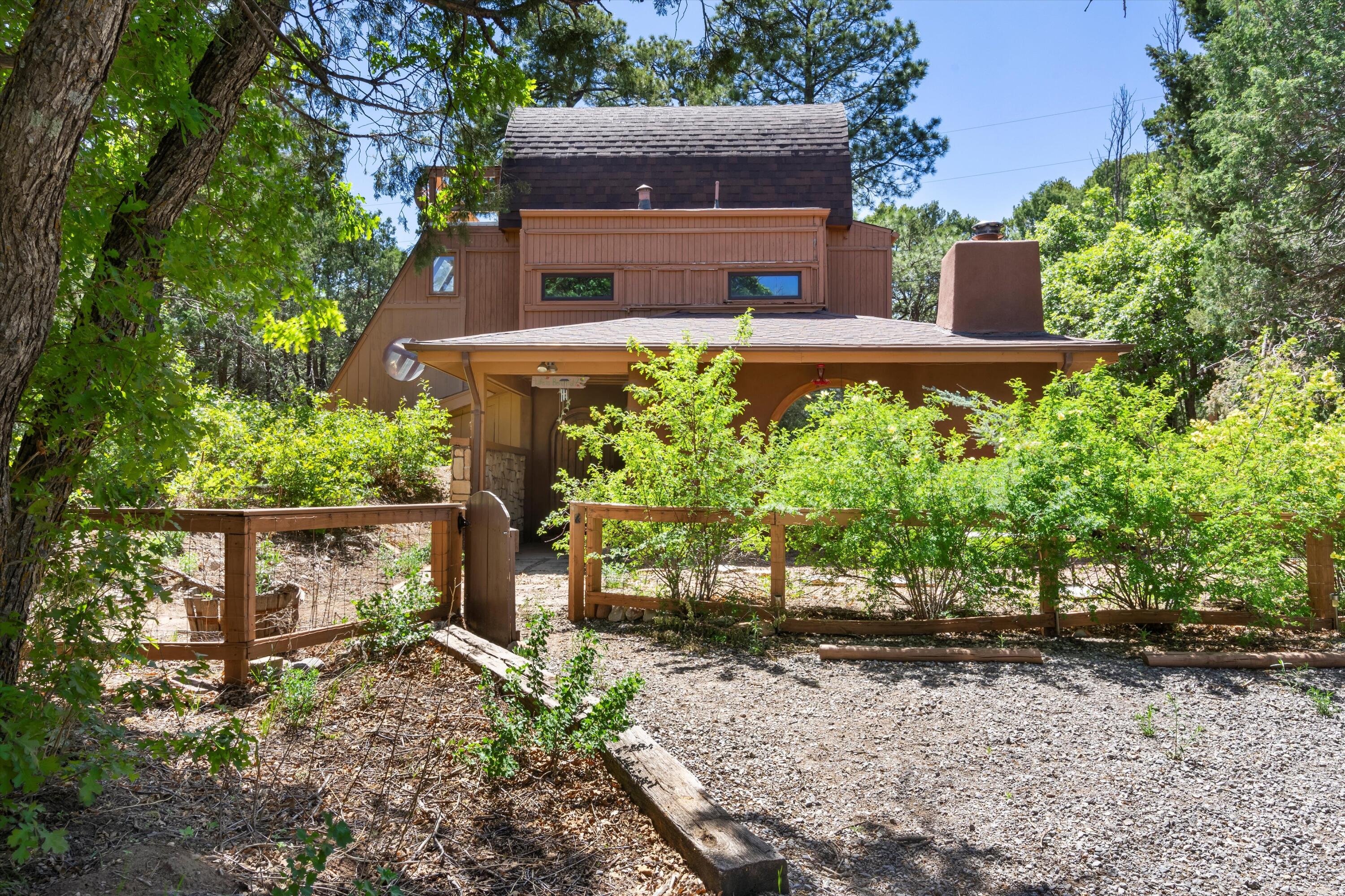 Escape to tranquility in this enchanting Warm & Cozy Tijeras Hideaway, where comfort meets convenience with Quick & Easy Access to ABQ! Nestled on a sprawling 1-acre wooded lot, this presents a Rare Opportunity to own a truly Unique home in the East Mountains.