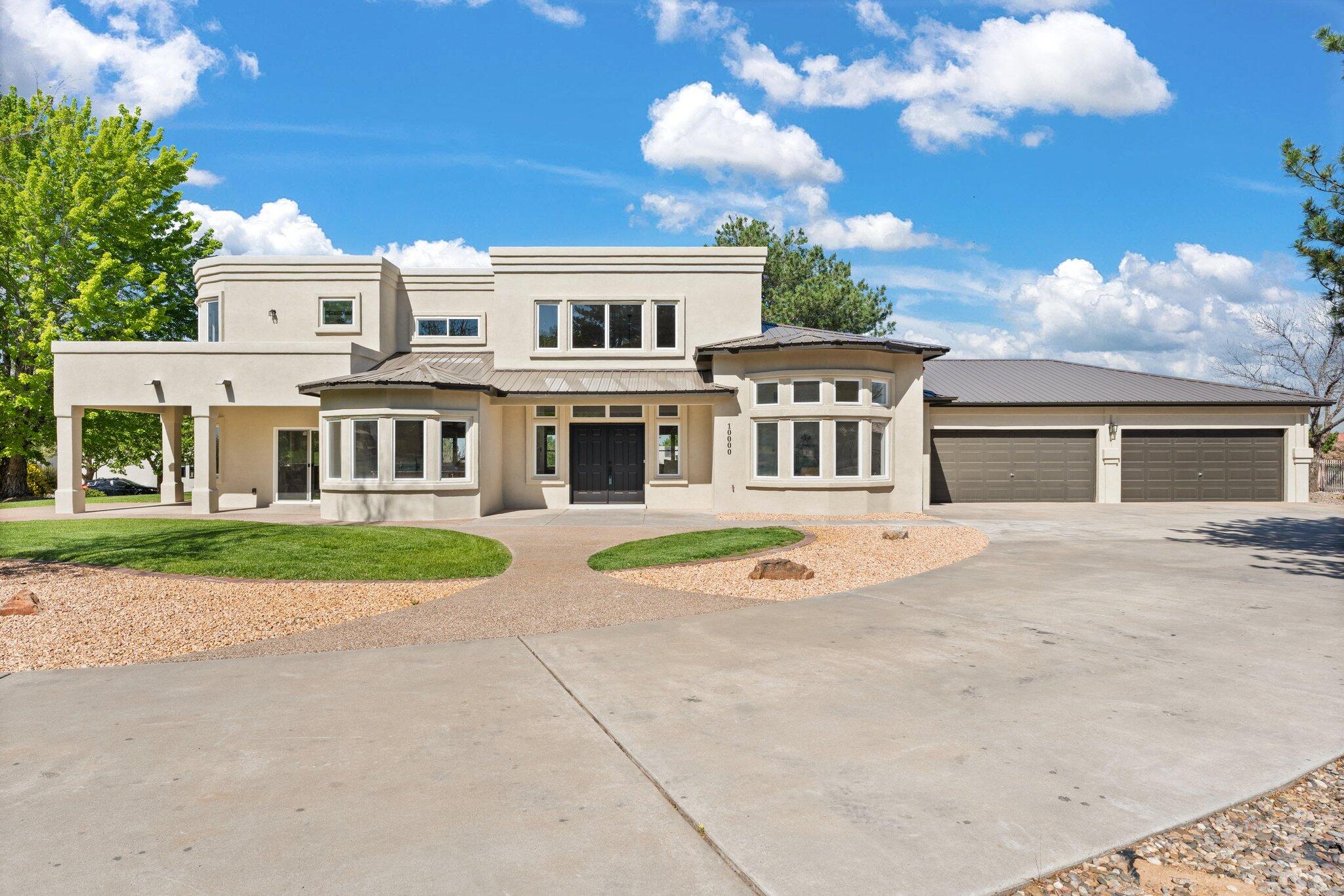 Impeccably redesigned custom beauty tucked away in a gated North Albuquerque Acres community! This expansive home boasts 4,720sf with 5 bedrooms, 3.5 bathrooms, 2 living areas, a loft and 4 car garage! Sleek and modern front living area greets you with upgraded floors and a soaring ceiling. Kitchen with designer cabinetry, honed granite countertops, built-in double oven, microwave, gas cooktop, range hood, fridge, large island and breakfast nook. 1st floor in-laws suite with a private bath. Beautiful office space with a wall of windows. Upstairs find the loft sitting area. Luxurious owners suite with a wet bar, sitting area, balcony and spa like bath. Bath hosts his/hers sinks, a dressing area, free standing tub, walk-in shower and closet. Yard lined with mature trees!