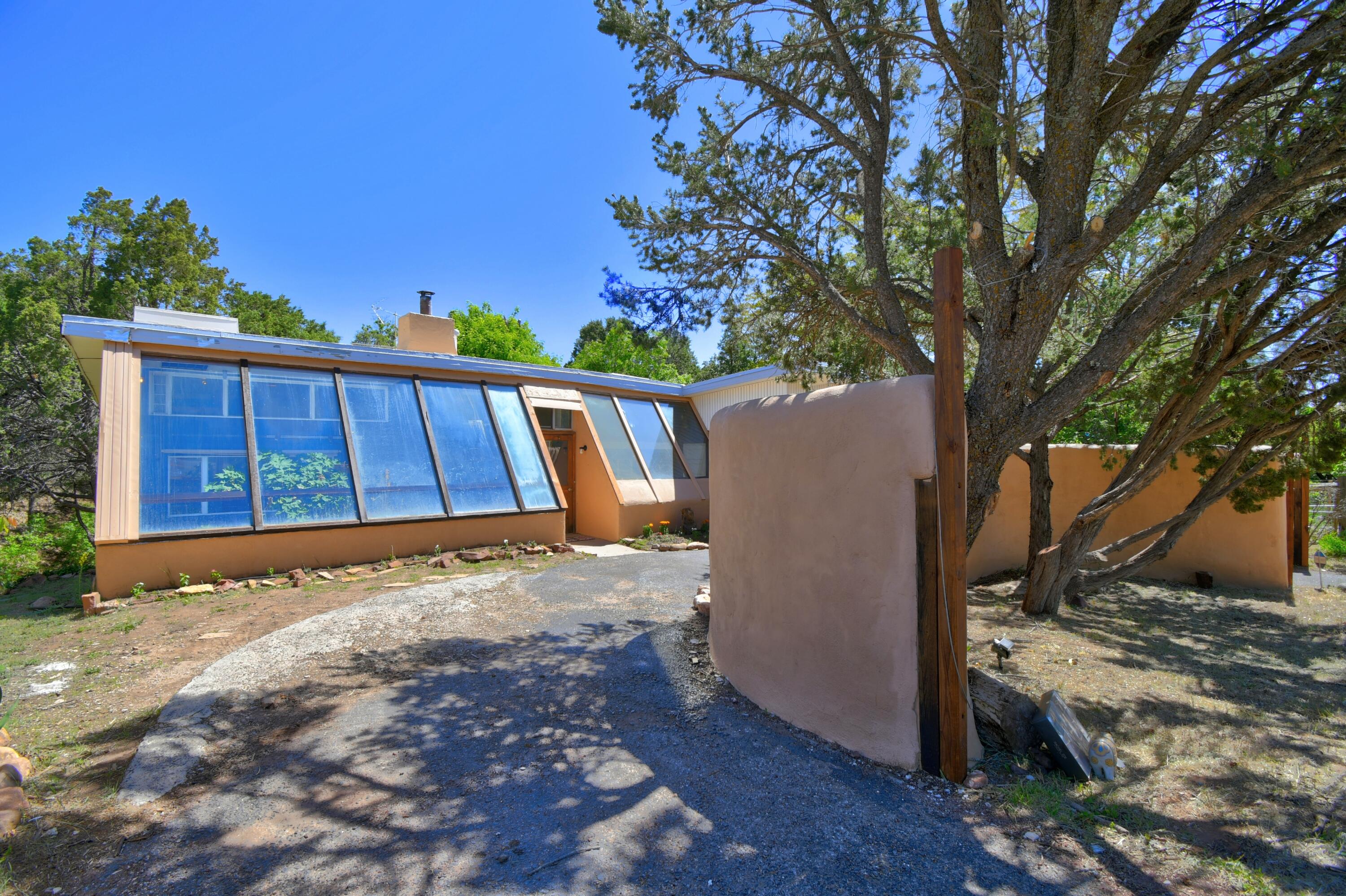 This newly decorated three bedroom two bath mountain hideaway is surrounded by fruit trees, and your own arroyo in the backyard. Wood floors flowing from the main room through the kitchen and main bedroom. Your own atrium to grow whatever your hearts desire. If you're looking for a mountain Hideaway, but still close to Albuquerque this is it this home is a must see.