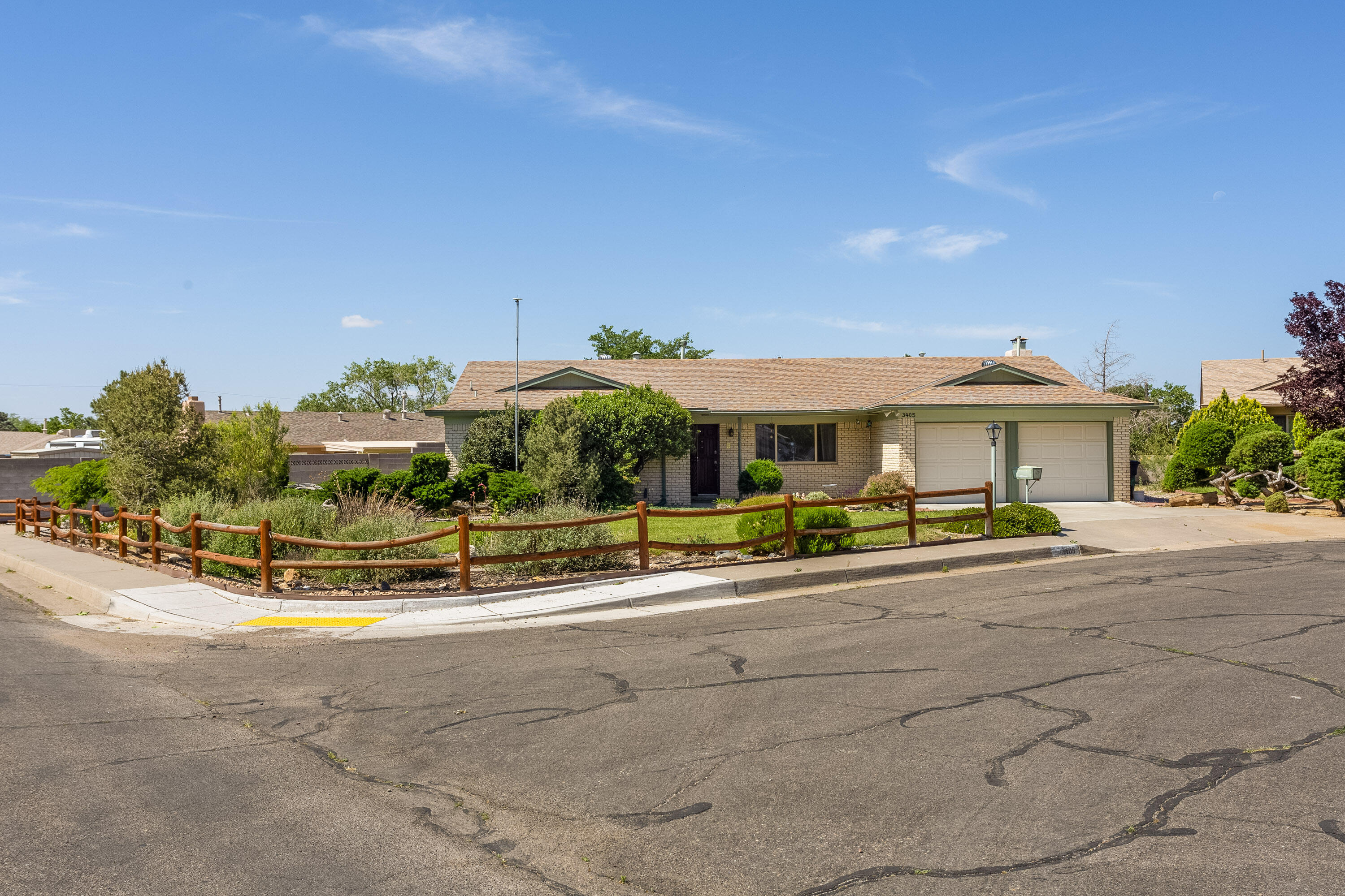 Welcome to this charming Holiday Park home situated on a large, corner lot in a cul-de-sac. This home has been lovingly cared for by the same owner for the last 40 years. Drive up to the excellently manicured front landscaping where you can see stunning views of the Sandias. This classic Rutledge/Brown floor plan boasts two living areas, a bay window and a light and bright kitchen with a window that overlooks the immaculate backyard. Outside you will find side-yard access with RV parking; a turf lawn for easy maintenance; beautiful rose bushes, a storage shed and a covered redwood deck. The lot and landscaping are the highlights of this home. Stay cool in the summer with refrigerated air & updated windows. The Bridges on Tramway is within walking distance, moments from schools, & grocery.