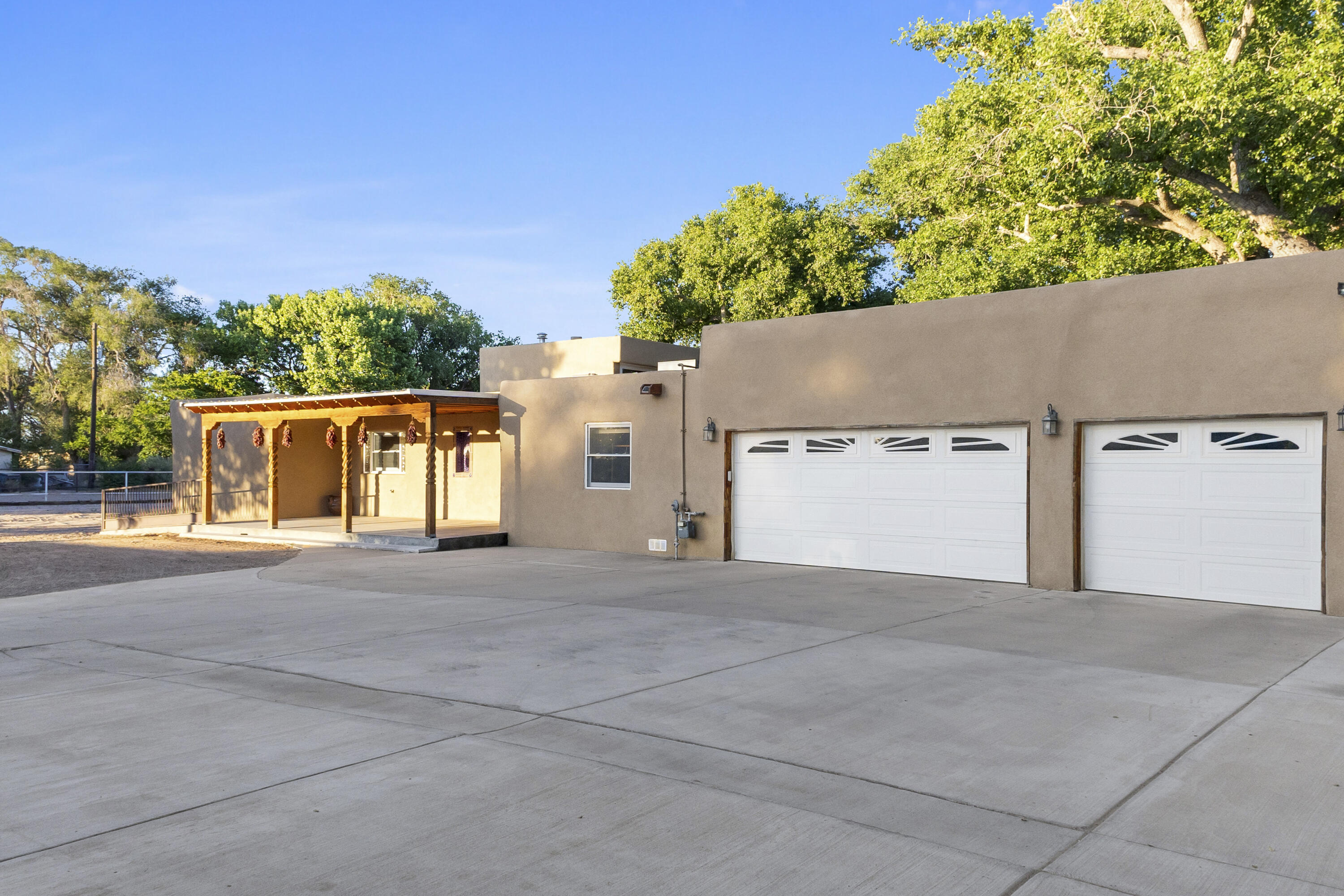 Welcome home to this great Horse Property. The quiet, serene setting makes living easy in this amazing home.  Southwestern accents include, beamed ceilings with vigas, 3 fireplaces, and exposed adobe walls.  Chef's kitchen boasts granite countertops, solid wood cabinets and stainless steel appliances. The enclosed patio (875 sq/ft)is great for entertaining, features include:  mini-split system installed in 2024 for heating and cooling, full kitchen with appliances, and granite countertops. This horse property includes 30' x 50' metal building with kitchenette and roll-up door,  pipe fencing, corrals, OWNED solar panels and irrigation well. Recent additions