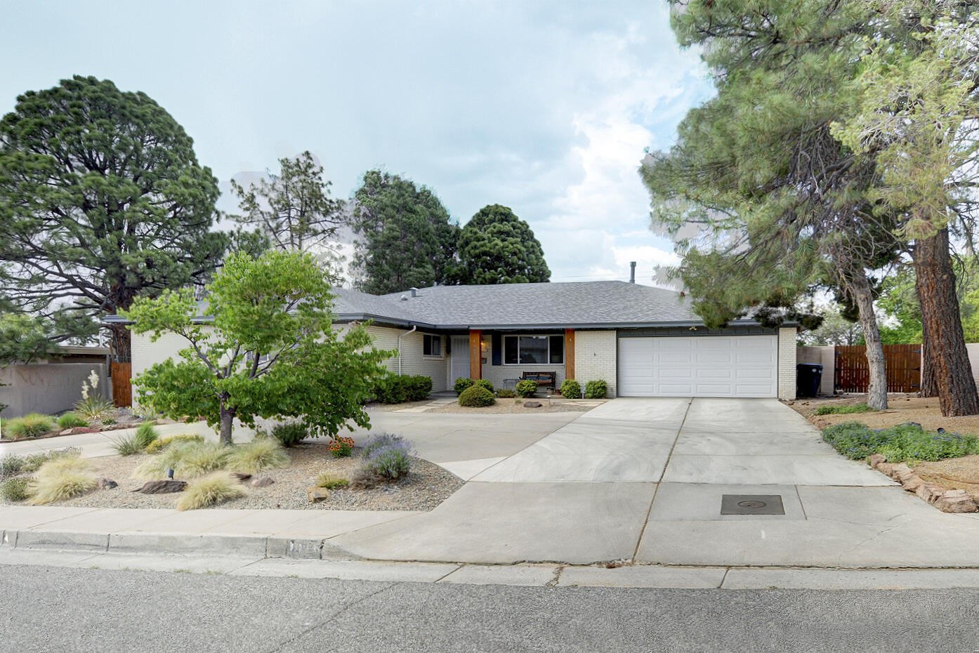 Lovely Spacious light-filled Mossman home with numerous upgrades. Located near the UNM North Golf Course and the UNM Law and Medical school. Flowing floor plan is perfect for entertaining. Beautiful refinished hardwood floors in LR, DR, and 4 bedrooms. Complete eat-in  kitchen remodel in 2020 with granite counter tops, refaced cabinets, 2 pantries + upscale ss appliances.  Dramatic skylight in the kitchen. Large 19'x 20' family room with fireplace, built-ins, plus French doors to back patio,. Huge master bedroom suite w/ 3 closets including 1 walk-in. Updated baths. New roof 2018 w/10 year warranty. Newer central A/C unit. New water heater 2021. 200 amp elec panel. .28 acre lot. Gracious front porch. Xeriscaped front yard. Shady newer ramada in the landscaped backyard. High privacy wall
