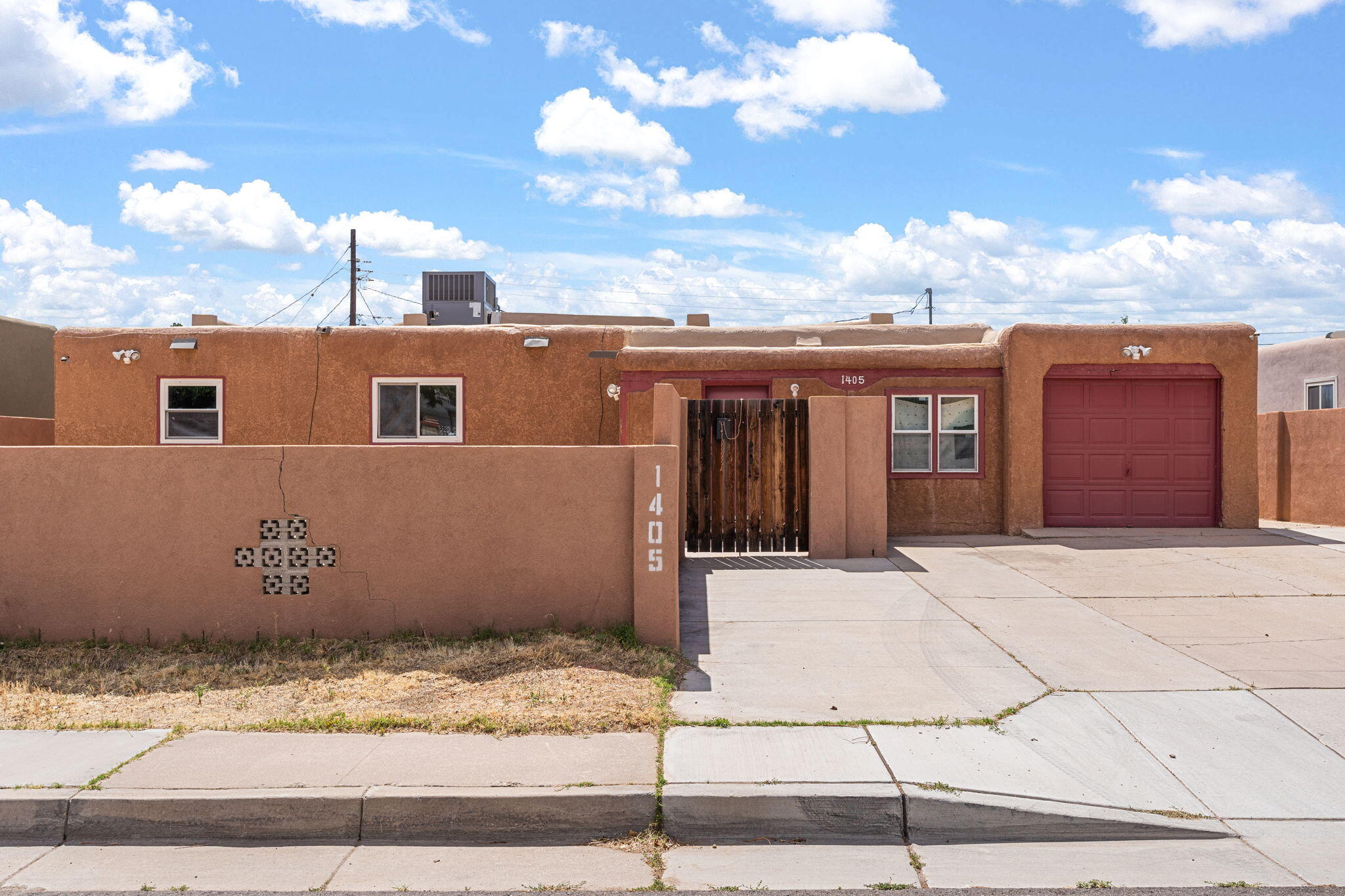 Great opportunity to make this spacious home your own. New HVAC system to include refrigerated air! Upgraded electrical Panel. Located near ABQ Uptown. Large courtyard offers privacy for relaxing and entertaining. This home offers versatility with 2 living areas, one with wood panel and cozy wood burning fireplace. Kitchen offers an eat-in bar, built- in cutting board and a breakfast nook! All appliances convey! 4 bedrooms, 2 baths. The 4th BR could easily flex into a private office or workout space. Oversized finished 1 car garage. Enjoy the convenience of being near shopping, dining, and a park! Winrock and the new community park.