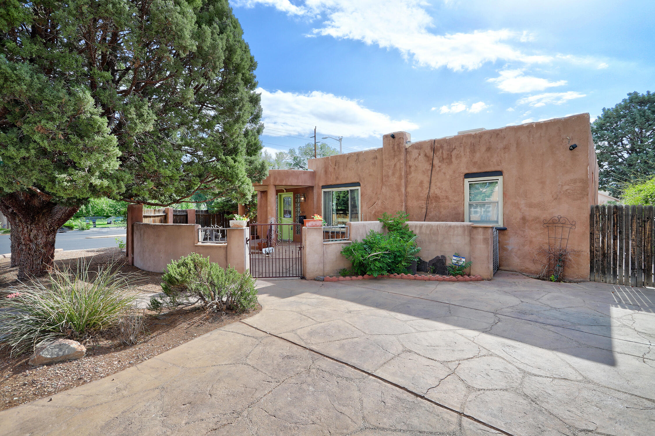 Great price reduction!! Iconic Pueblo Style home boasts 4BR/3BA/2143 sq ft and is located in a highly sought-after NobHill/UNM neighborhood. Bright open floor plan / 3 spacious bedrooms / 2 updated baths and kitchen w plenty of storage in main house w a  1bd/1ba attached casita / separate entrance / generous great room / wood burning fireplace /  plus an oversized 1 car gara.  Enjoy the enviable New Mexico climate beside the custom-built fountain and gated patio at the front of the property. Additional storage shed in spacious back yard, RV gated+parking. Ideally located, family friendly, and massive potential for income generation makes this rare find in highly desirable Land Of Enchantmen.  Rent one and live in the other or rent both for max return on your $$$