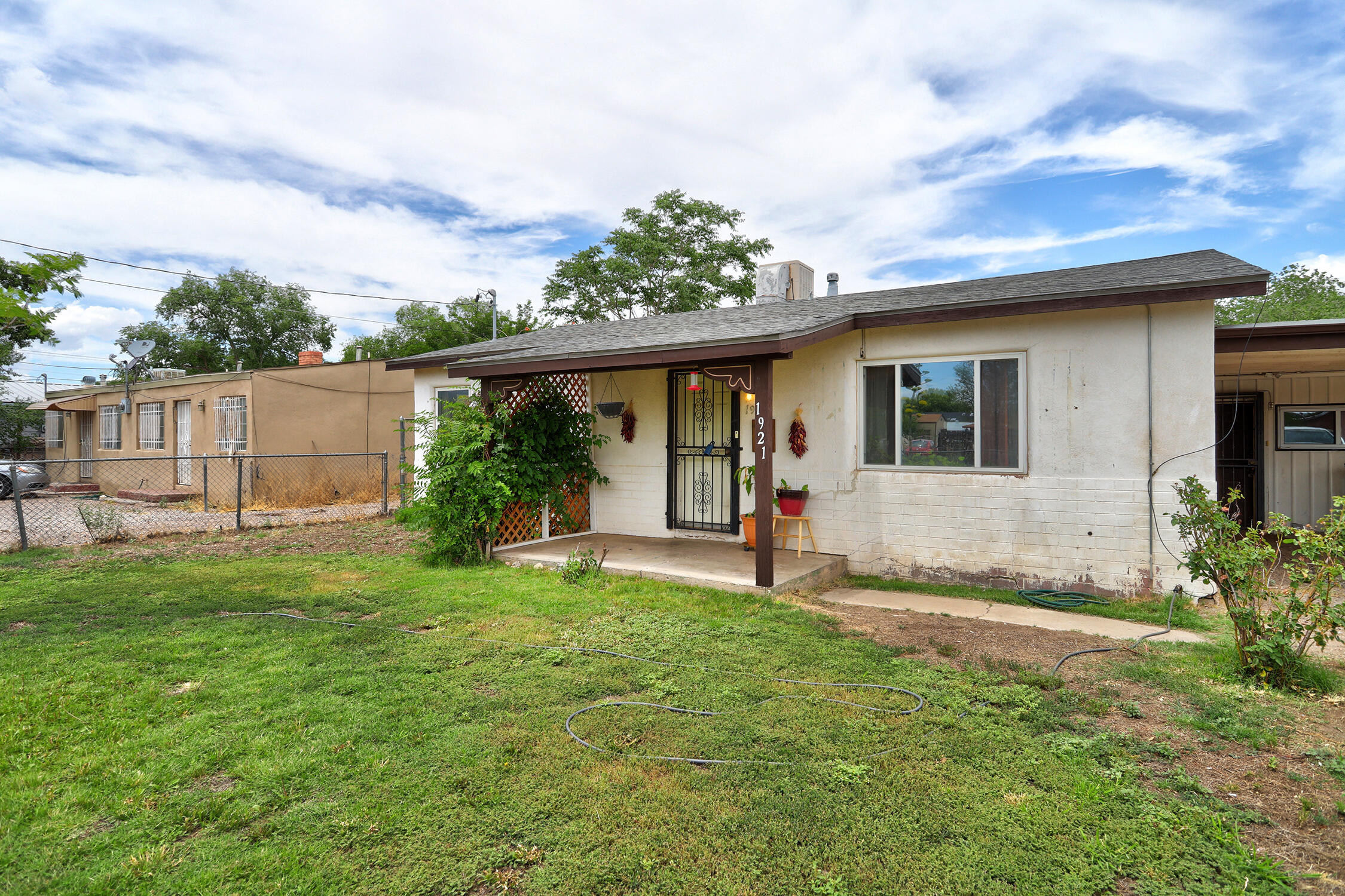 Make this home your own! Enjoy country living in  this roomy 4 BR/1 Bath  on  a .66 ac lot! Updates over time include a  spacious eat in kitchen with stainless gas range and refrigerator, electrical box replaced; addition which adds a second living area/den with wood burning stove and ducted evaporative cooling; roof redone in the last 3-5 years. Addition area including den, 2 BR's and laundry room have concrete floors.Carport and ample driveway for parking.  Desirable back yard access. Shed and chicken coop stay.Shower in laundry room is inoperable.